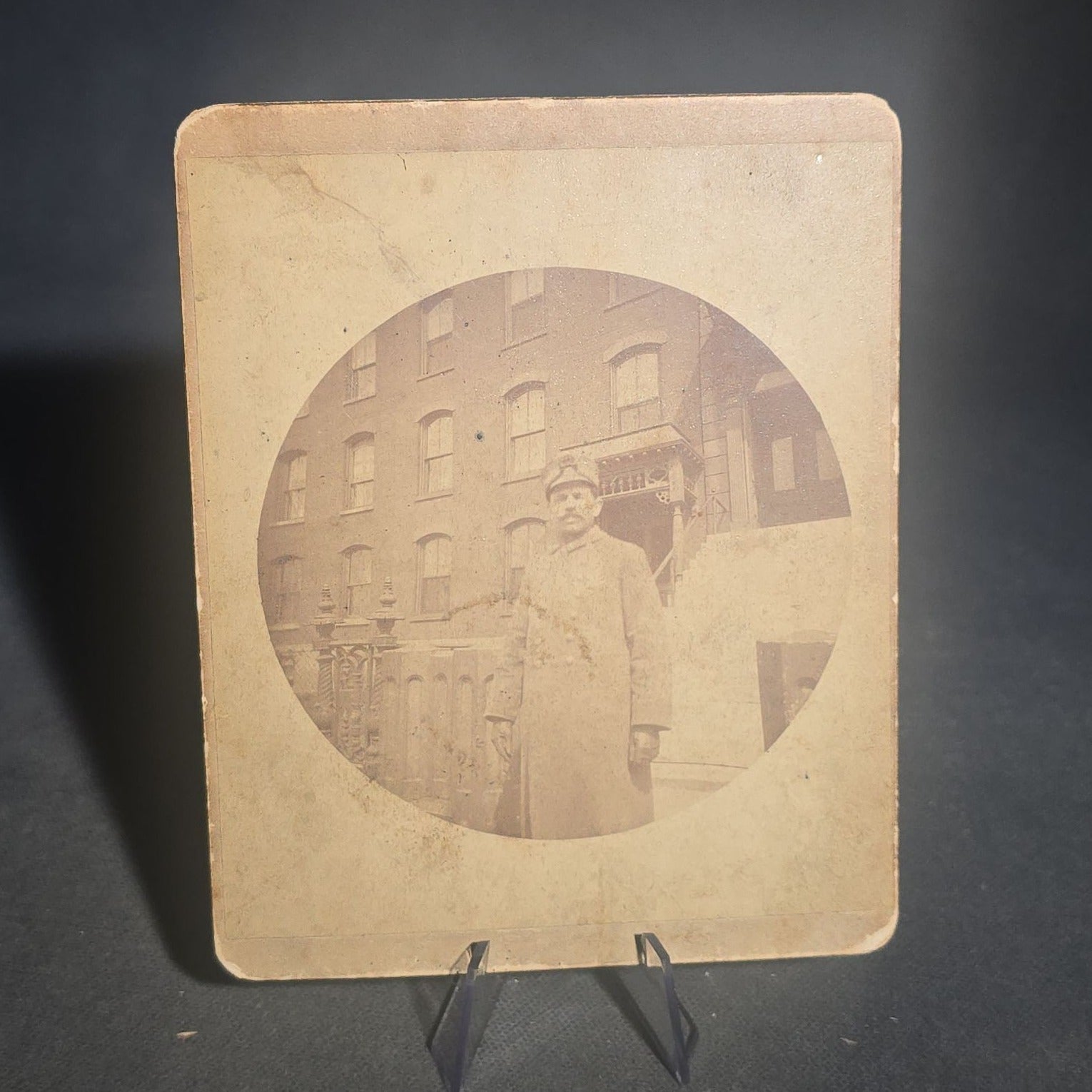 Grouping of Five Antique and Vintage Board-Mounted Photographs including Boy Holding a Box Camera, Two Men in Uniform, Family Eating Watermelon, and Dog Looking Out a Window, One Photographed by Rogers, New Haven, Connecticut
