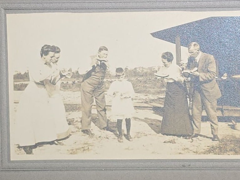 Grouping of Five Antique and Vintage Board-Mounted Photographs including Boy Holding a Box Camera, Two Men in Uniform, Family Eating Watermelon, and Dog Looking Out a Window, One Photographed by Rogers, New Haven, Connecticut