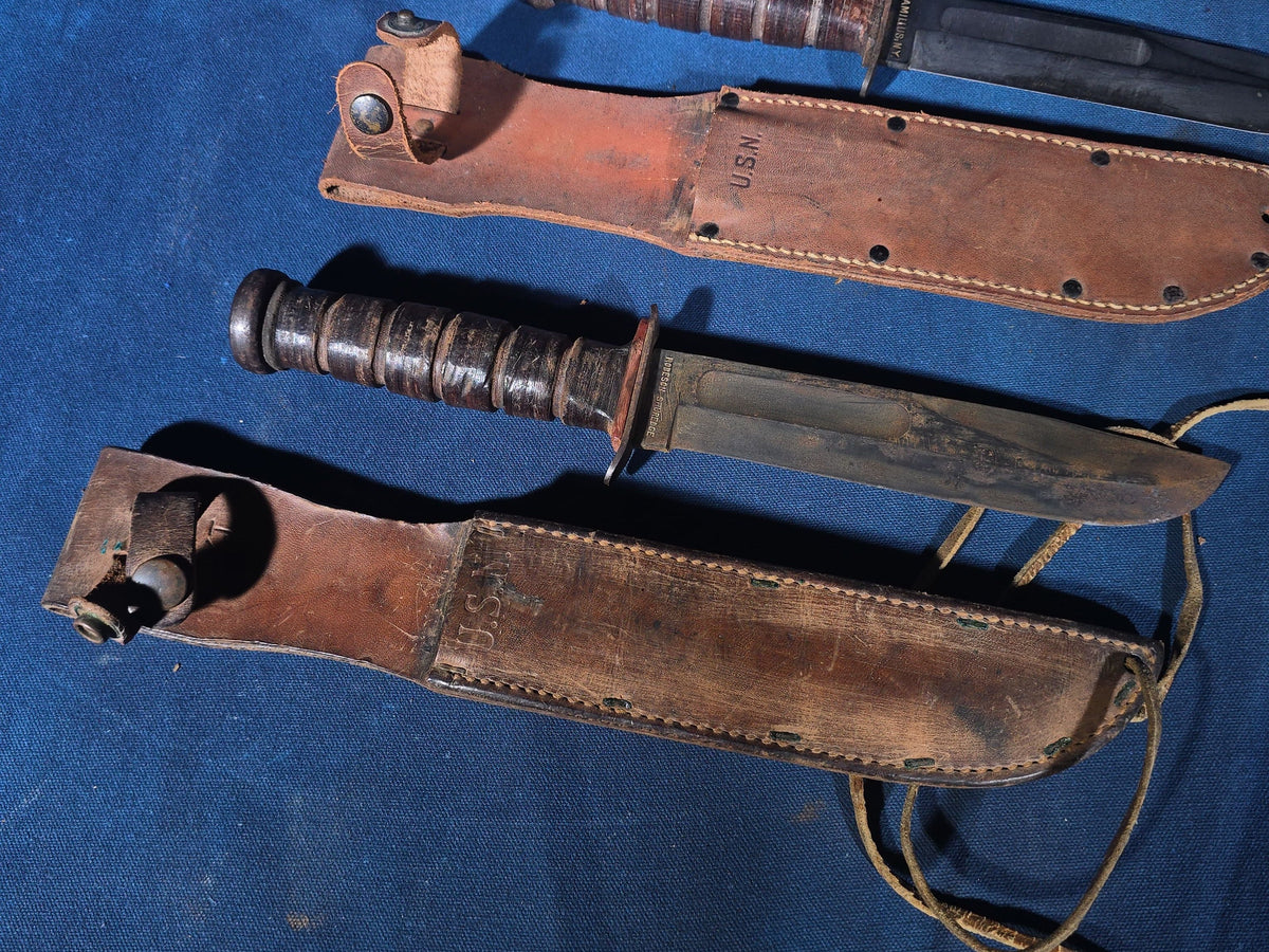 Pair of Vintage WWII U.S.N. Mark 1 Combat Knives with Leather Sheaths, Manufactured by Camillus and Robeson ShurEdge