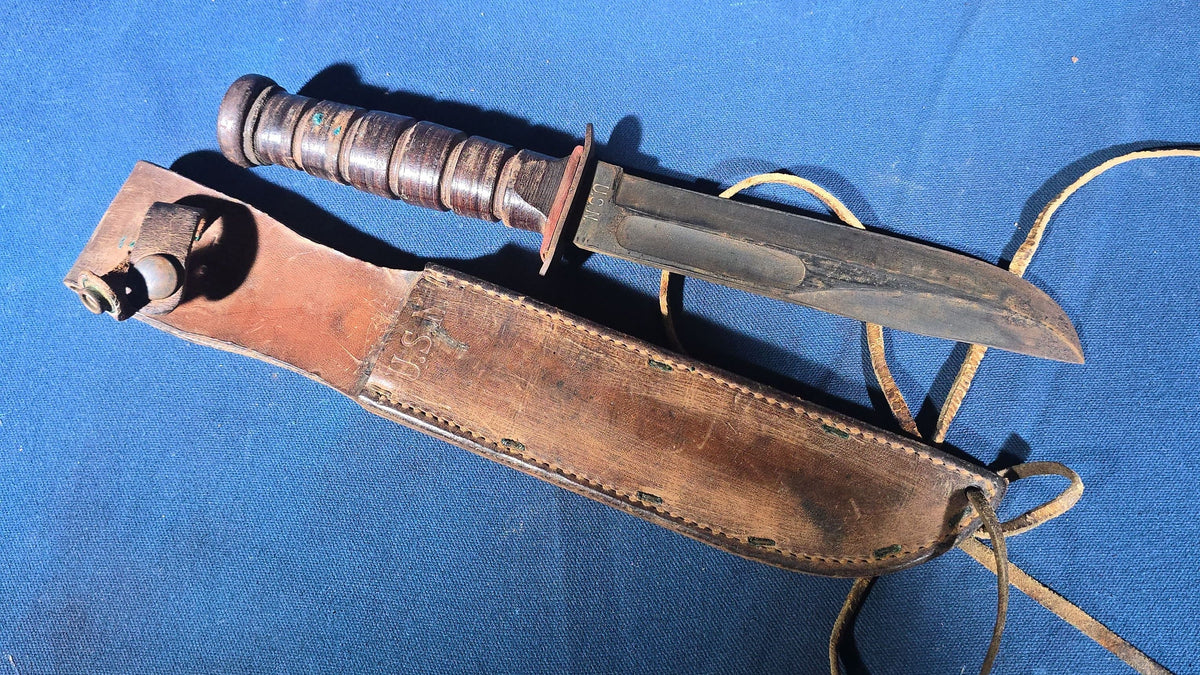 Pair of Vintage WWII U.S.N. Mark 1 Combat Knives with Leather Sheaths, Manufactured by Camillus and Robeson ShurEdge