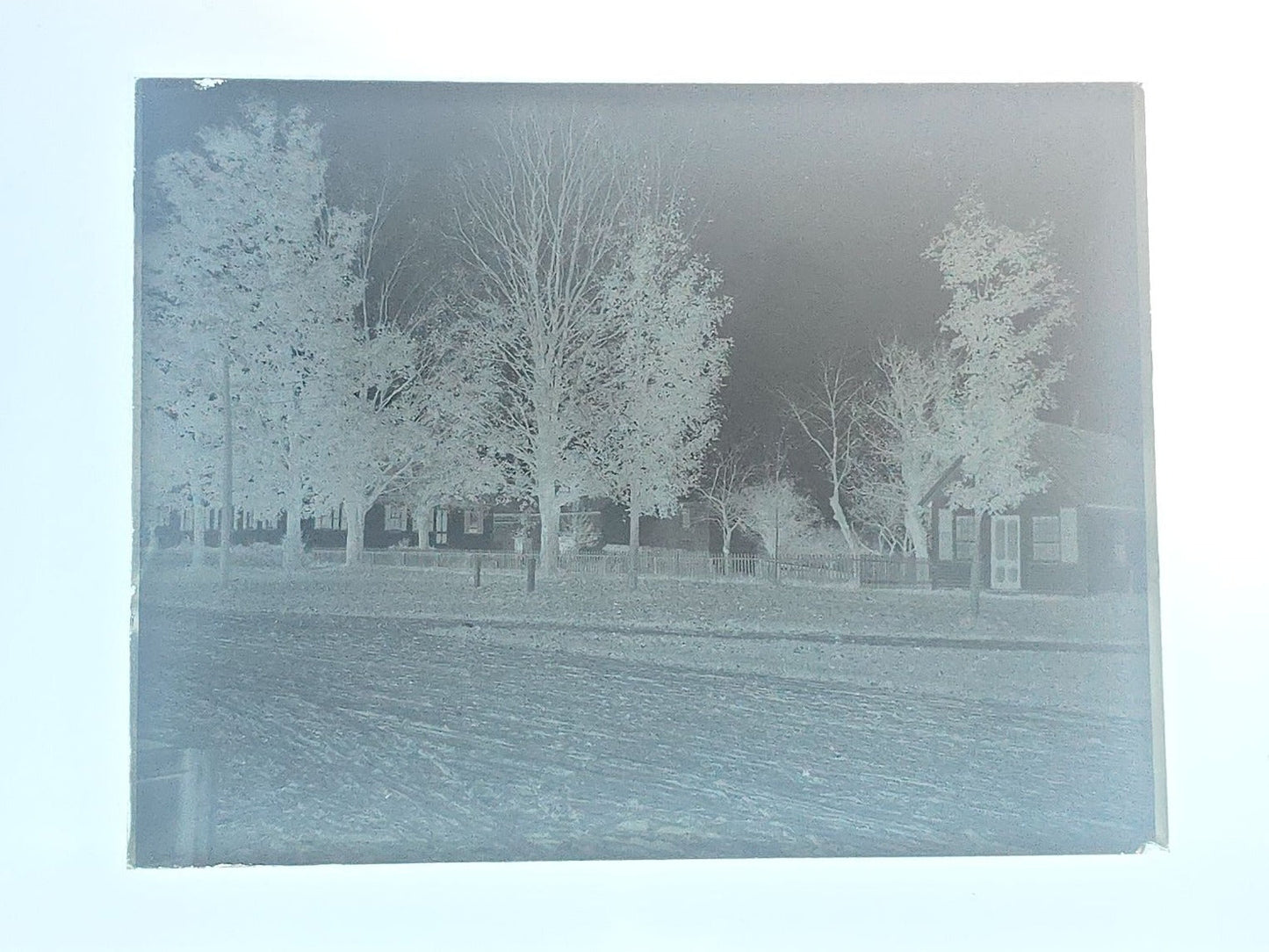 Grouping of 10 Antique Glass Plate Photographic Negatives in Cramer's Lightning Photo Dry Plates Box including Town Street Views, Man with Horse, and Residential Exteriors