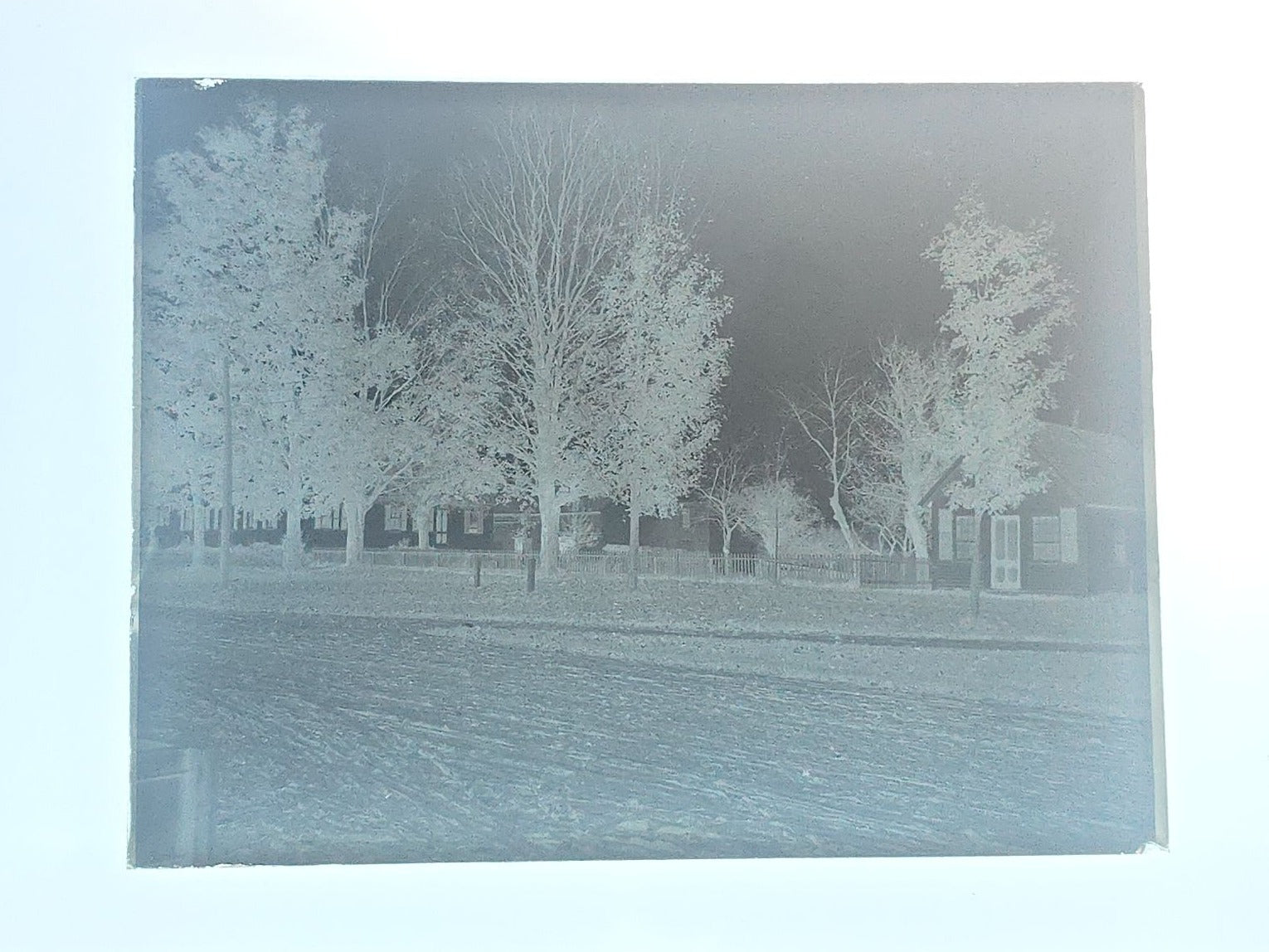 Grouping of 10 Antique Glass Plate Photographic Negatives in Cramer's Lightning Photo Dry Plates Box including Town Street Views, Man with Horse, and Residential Exteriors