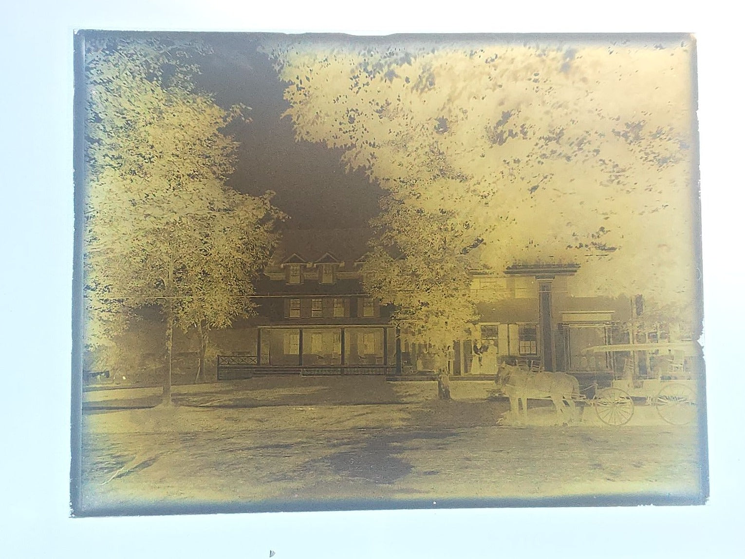 Grouping of 10 Antique Glass Plate Photographic Negatives in Cramer's Lightning Photo Dry Plates Box including Town Street Views, Man with Horse, and Residential Exteriors