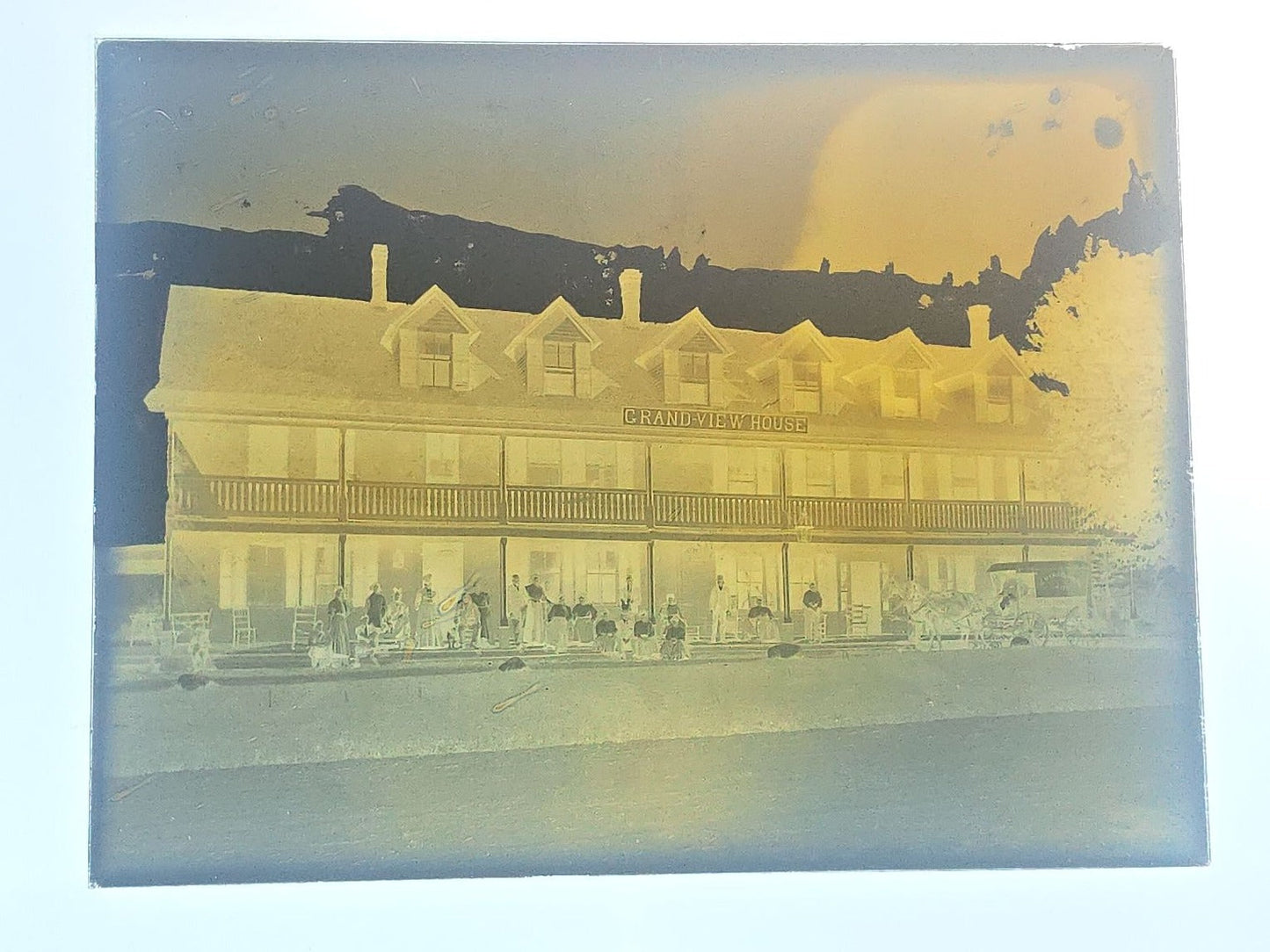 Grouping of 10 Antique Glass Plate Photographic Negatives in Cramer's Lightning Photo Dry Plates Box including Town Street Views, Man with Horse, and Residential Exteriors