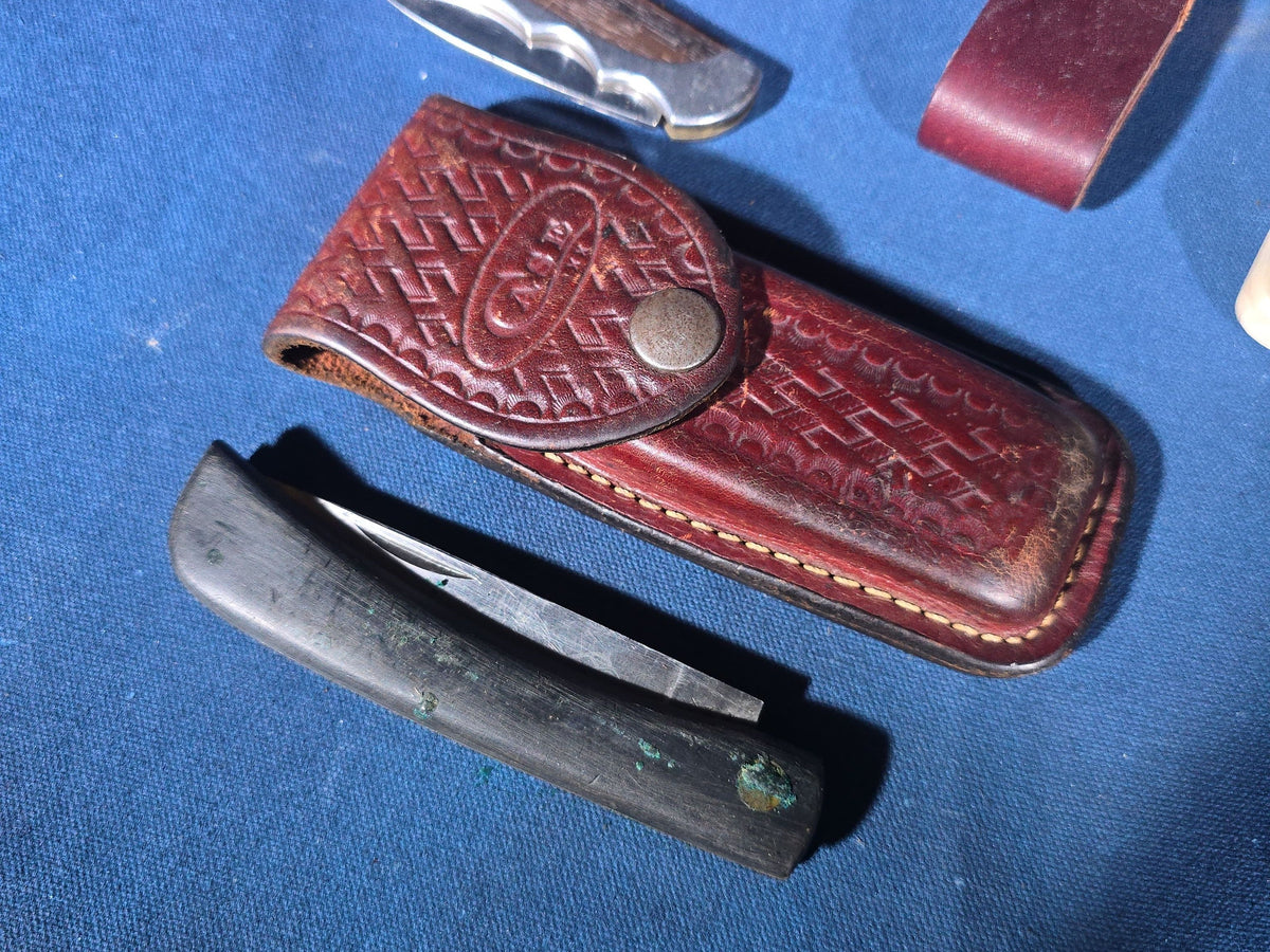 Grouping of 14 Vintage Folding and Pocket Knives with Sheaths including Buck, Schrade Old Timer, Western, Gerber, Case, and Opinel