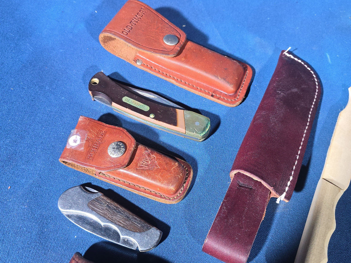 Grouping of 14 Vintage Folding and Pocket Knives with Sheaths including Buck, Schrade Old Timer, Western, Gerber, Case, and Opinel