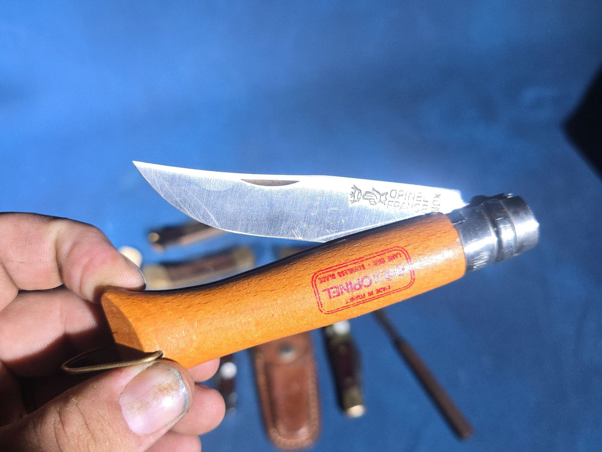Grouping of 14 Vintage Folding and Pocket Knives with Sheaths including Buck, Schrade Old Timer, Western, Gerber, Case, and Opinel