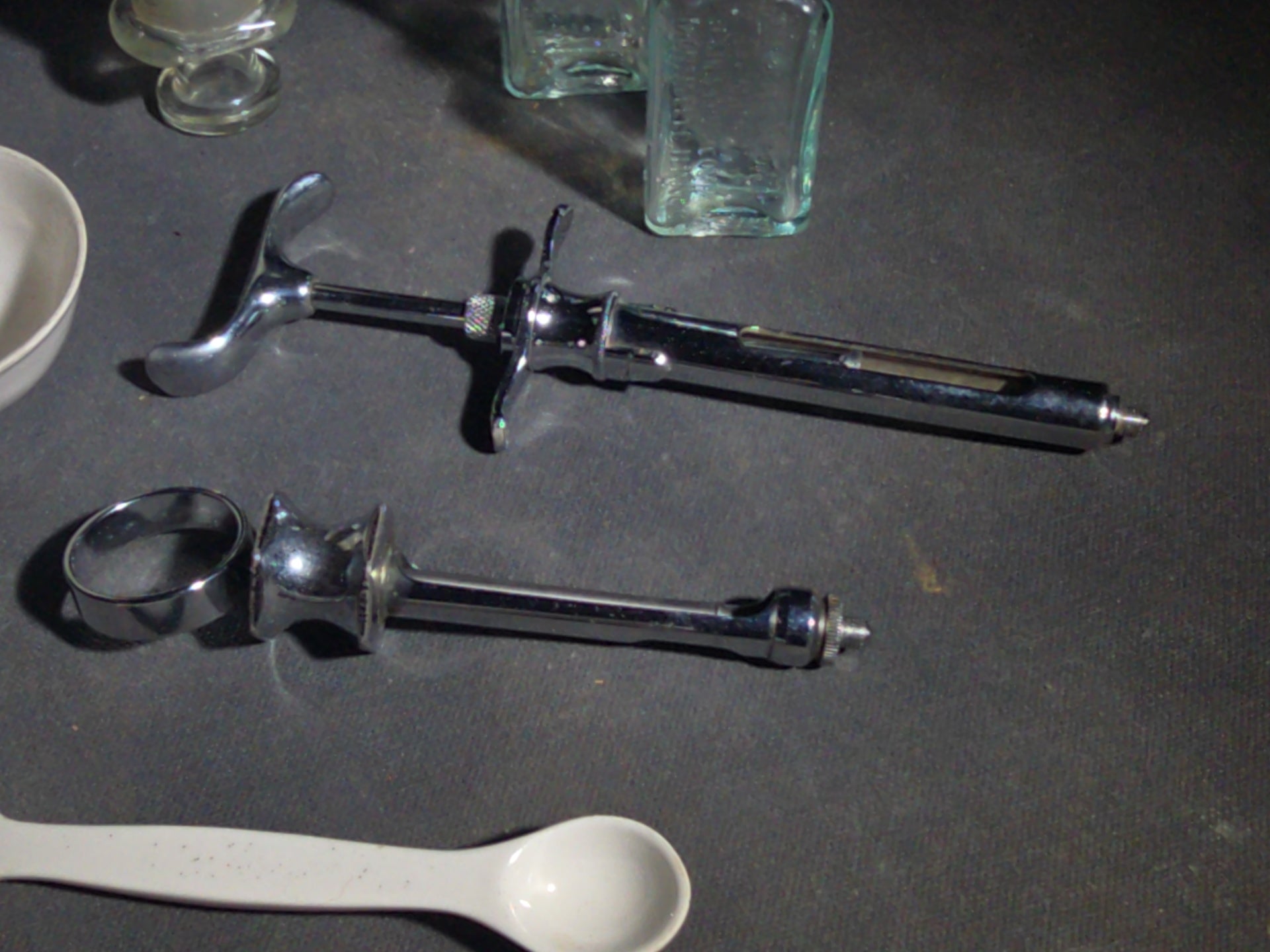 Grouping of Vintage Dental and Medical Pieces including Eli Lilly Merthiolate Twin Refill Box, Glass Syringe, and Chrome Dental Aspirating Syringe
