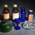 Lot 153 - Grouping of Seven Antique and Vintage Apothecary Smalls Including Belladona Leaves and Iodine Tincture Poison Bottles, Bichloride Mercury Poison Bottle, Cobalt Blue Eye Cup, and Sheaffer Skrip Ink Bottle