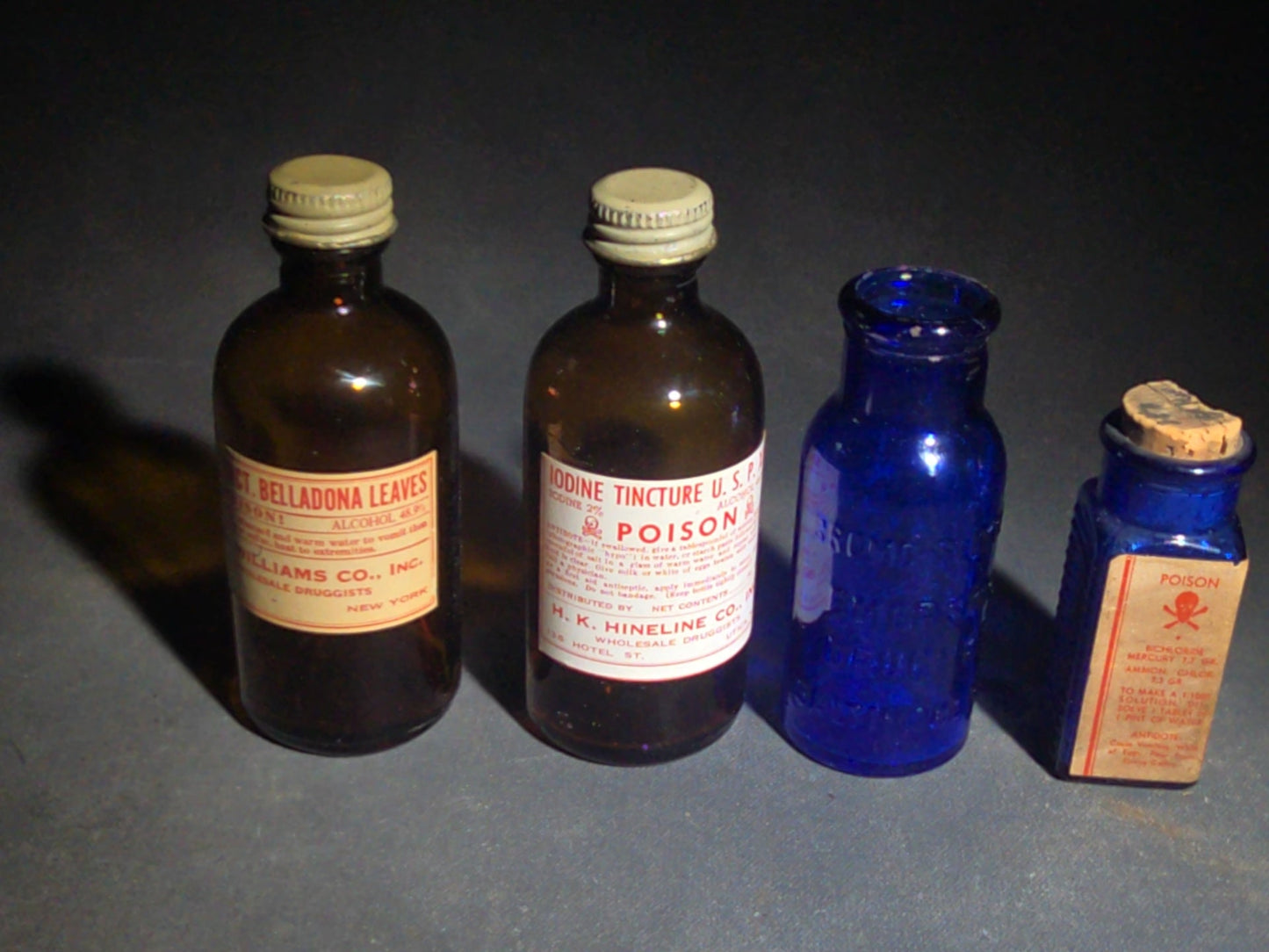 Grouping of Seven Antique and Vintage Apothecary Smalls including Belladona Leaves and Iodine Tincture Poison Bottles, Bichloride Mercury Poison Bottle, Cobalt Blue Eye Cup, and Sheaffer Skrip Ink Bottle