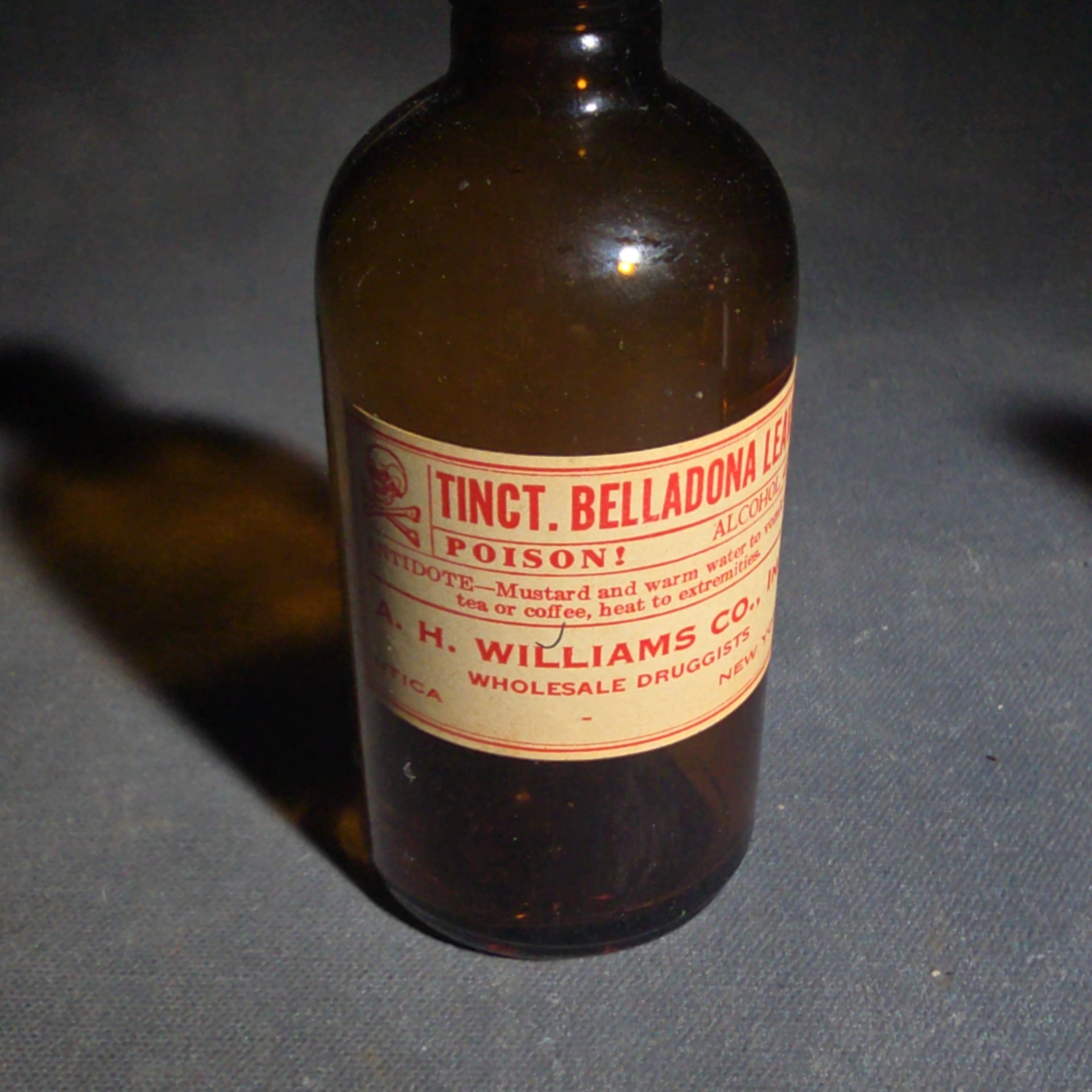 Grouping of Seven Antique and Vintage Apothecary Smalls including Belladona Leaves and Iodine Tincture Poison Bottles, Bichloride Mercury Poison Bottle, Cobalt Blue Eye Cup, and Sheaffer Skrip Ink Bottle