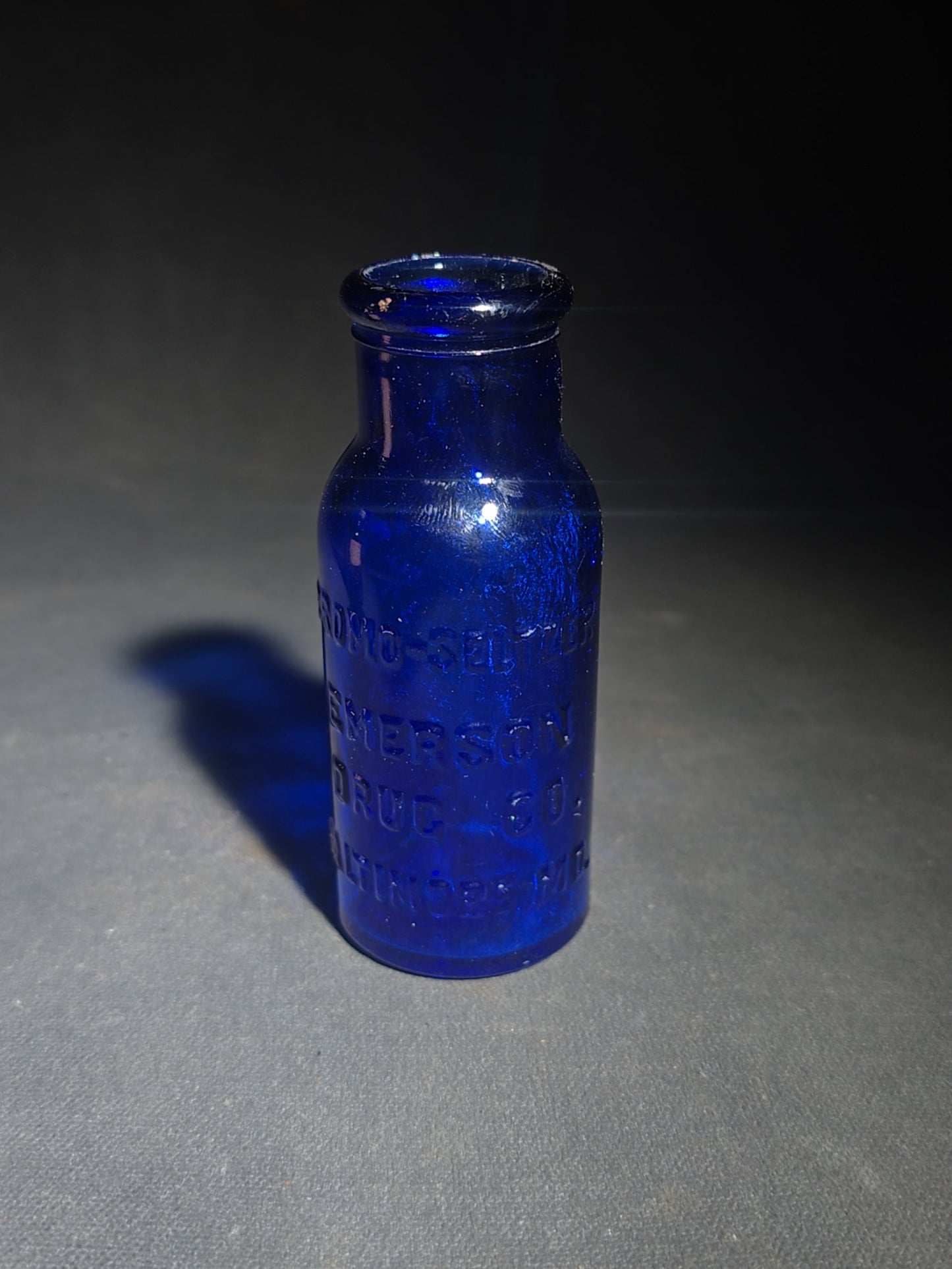 Grouping of Seven Antique and Vintage Apothecary Smalls including Belladona Leaves and Iodine Tincture Poison Bottles, Bichloride Mercury Poison Bottle, Cobalt Blue Eye Cup, and Sheaffer Skrip Ink Bottle