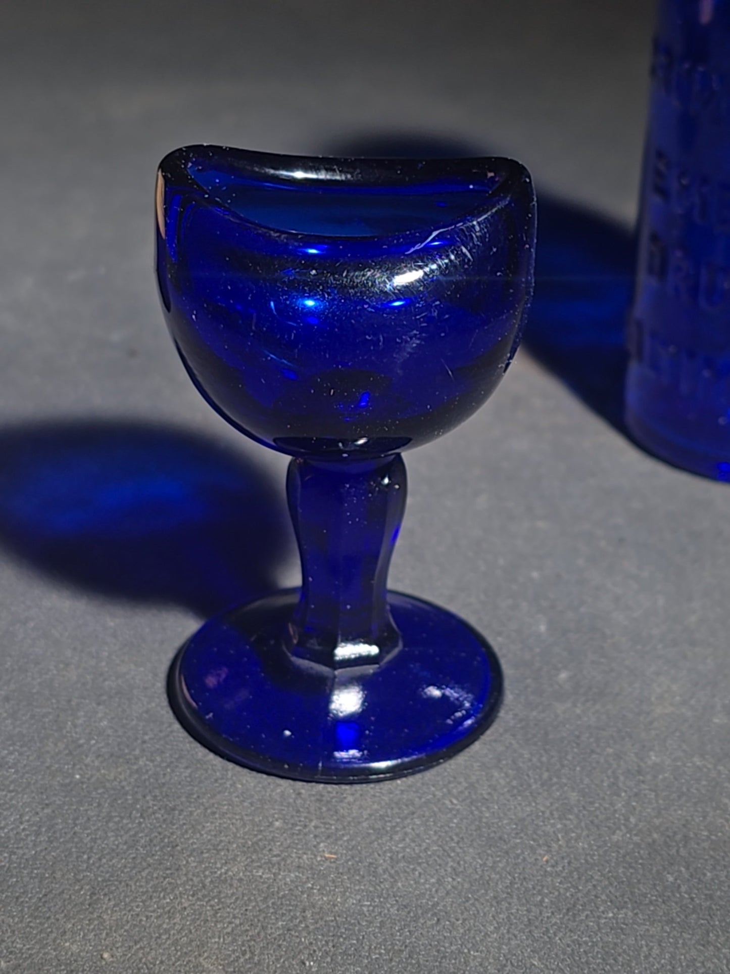 Grouping of Seven Antique and Vintage Apothecary Smalls including Belladona Leaves and Iodine Tincture Poison Bottles, Bichloride Mercury Poison Bottle, Cobalt Blue Eye Cup, and Sheaffer Skrip Ink Bottle