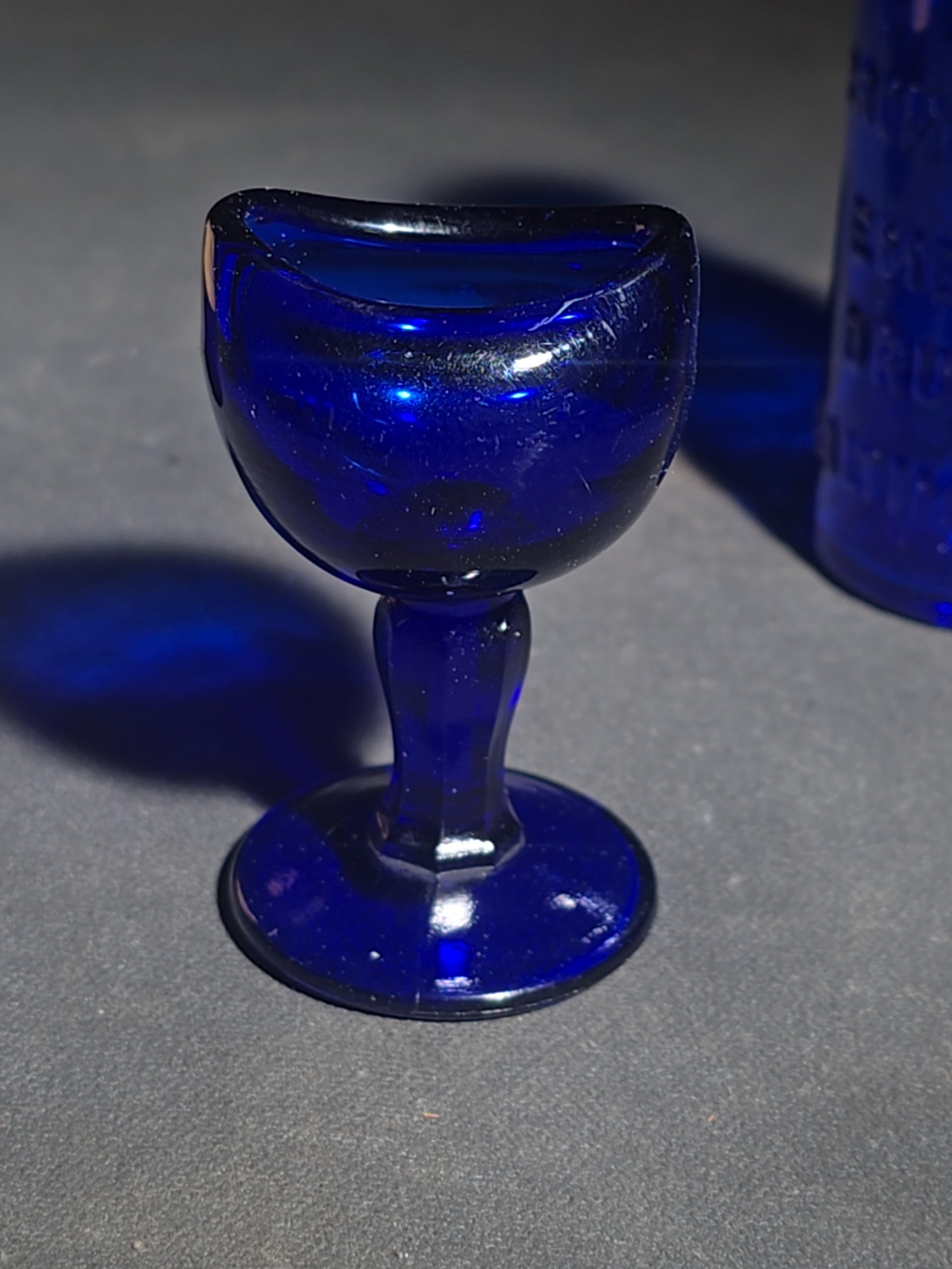 Grouping of Seven Antique and Vintage Apothecary Smalls including Belladona Leaves and Iodine Tincture Poison Bottles, Bichloride Mercury Poison Bottle, Cobalt Blue Eye Cup, and Sheaffer Skrip Ink Bottle