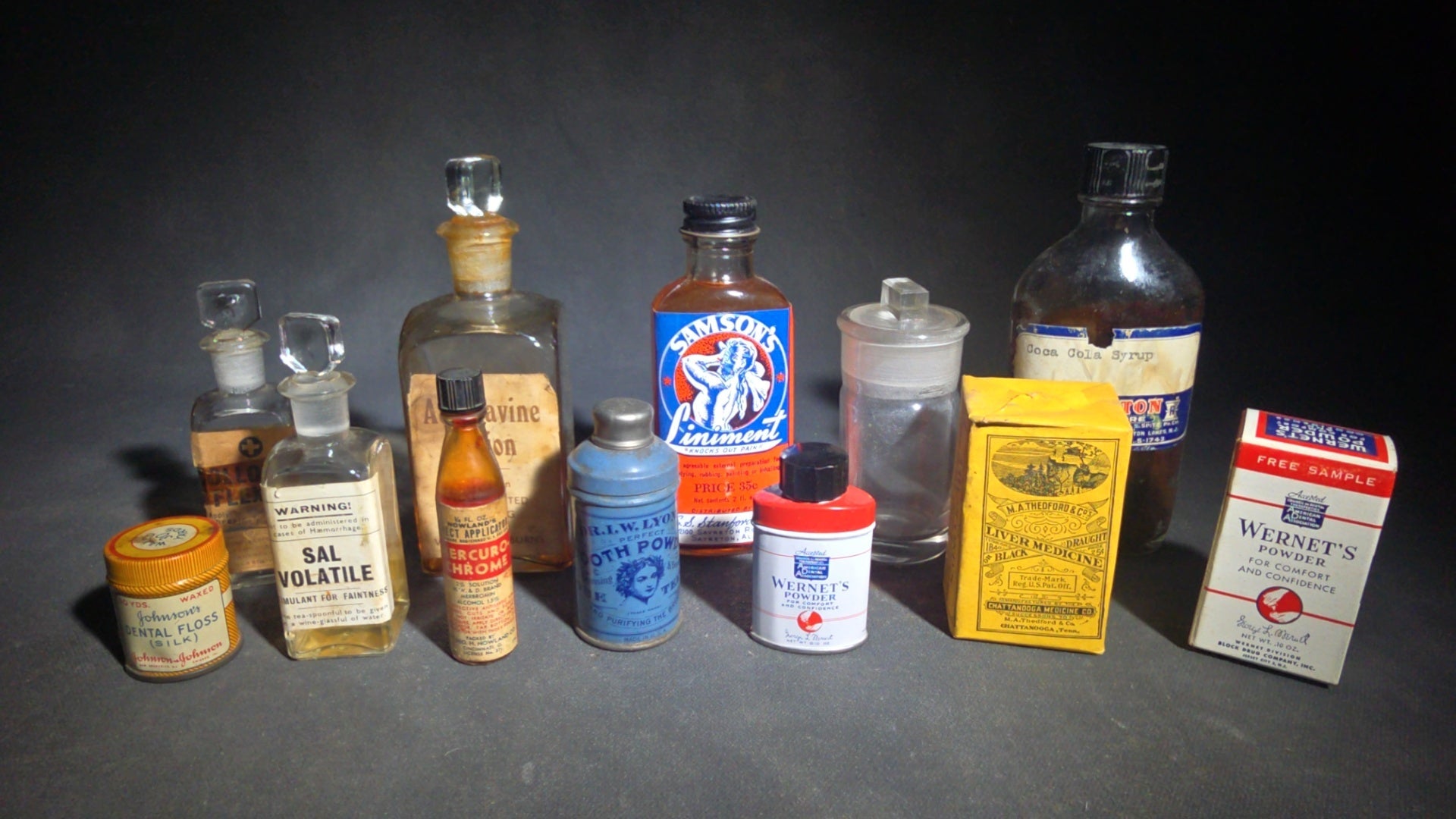 Grouping of 12 Antique and Vintage Pharmaceutical Bottles and Tins including Samson's Liniment, M.A. Thedford's Black Draught Liver Medicine, Dr. I.W. Lyon's Tooth Powder, and Johnson & Johnson Dental Floss