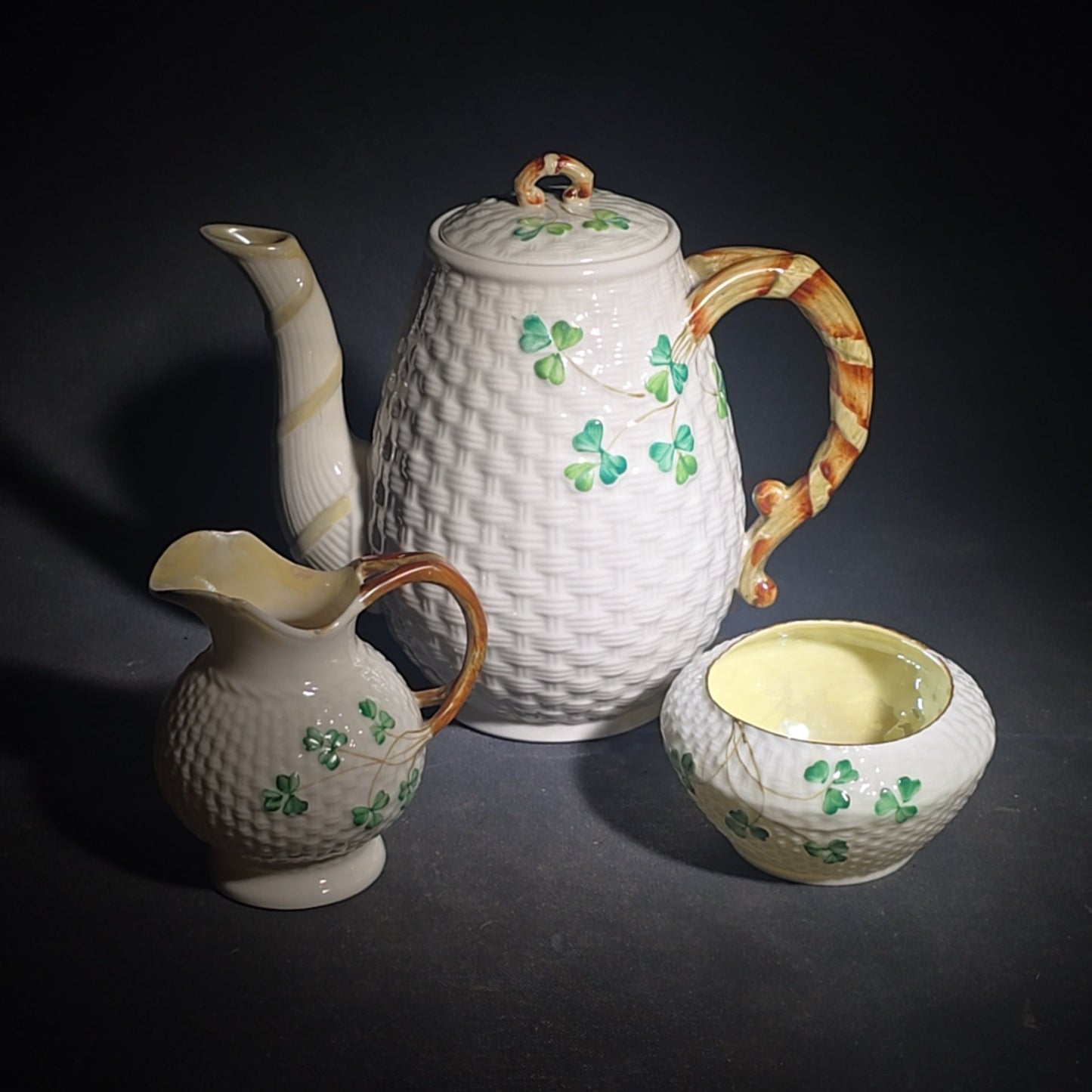 Trio of Vintage Belleek Shamrock Basketweave Pieces including Coffeepot, Creamer, and Open Sugar Bowl, Co. Fermanagh, Ireland, Note Chipping to the Creamer