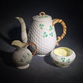 Lot 137 - Trio of Vintage Belleek Shamrock Basketweave Pieces Including Coffeepot, Creamer, and Open Sugar Bowl, Co. Fermanagh, Ireland, Note Chipping to the Creamer, 7" H