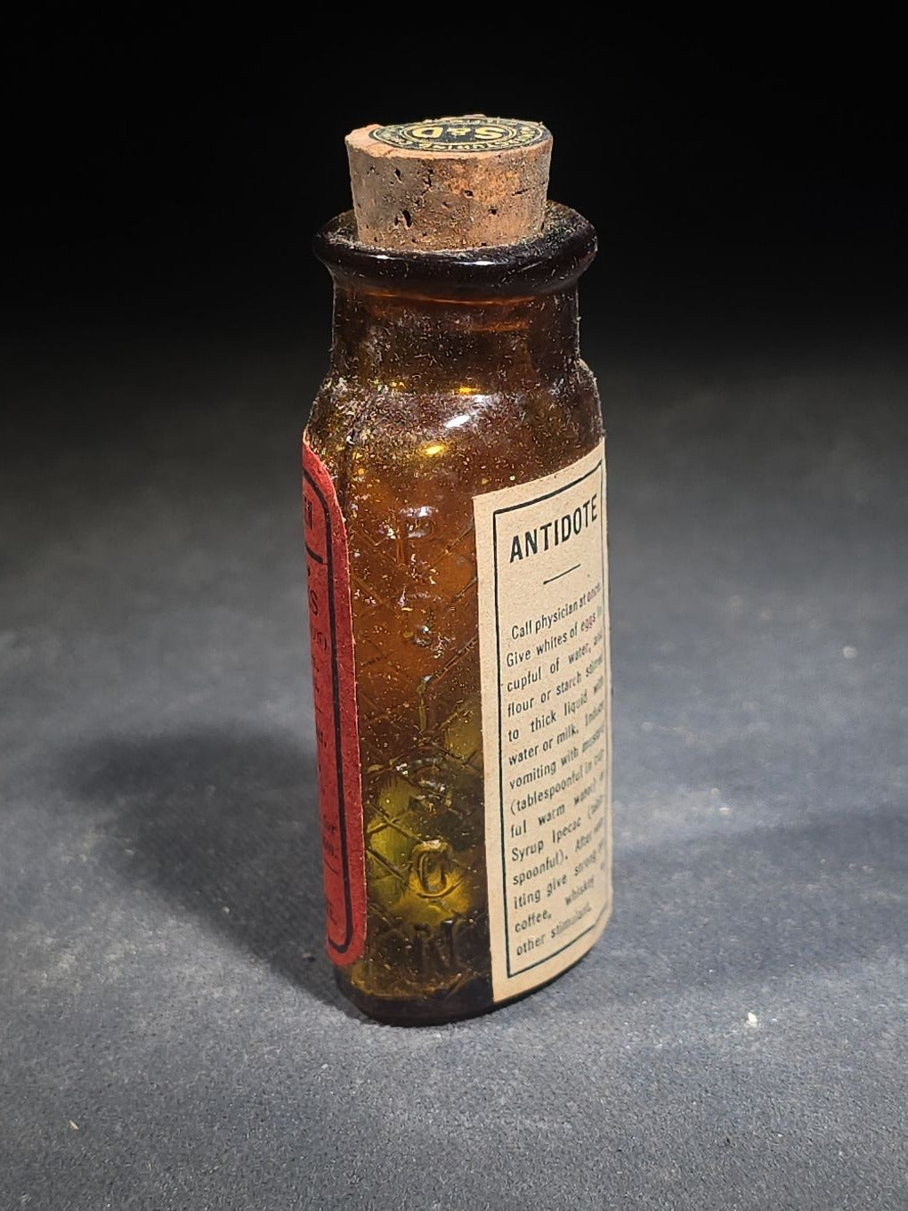 Antique Sharp & Dohme's No. 25 Green Antiseptic Disks Embossed Amber Poison Bottle with Cork, Antidote Label, and Original Cardboard Tube, Baltimore, Maryland