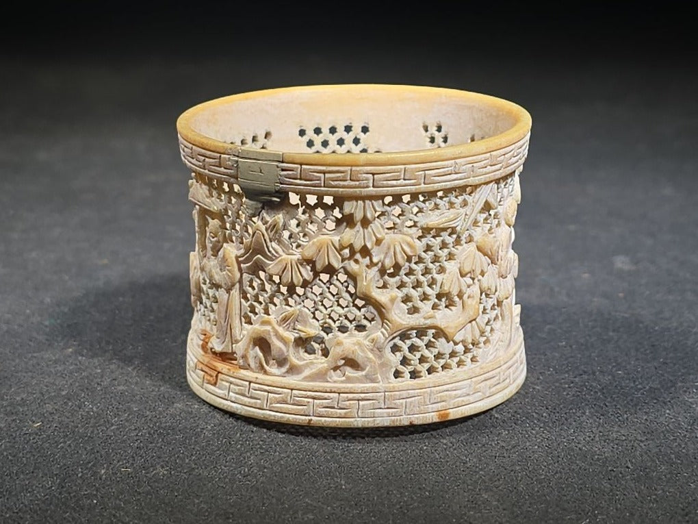Antique Chinese Carved and Reticulated Bone Napkin Ring with Figures in Landscape and Geometric Borders