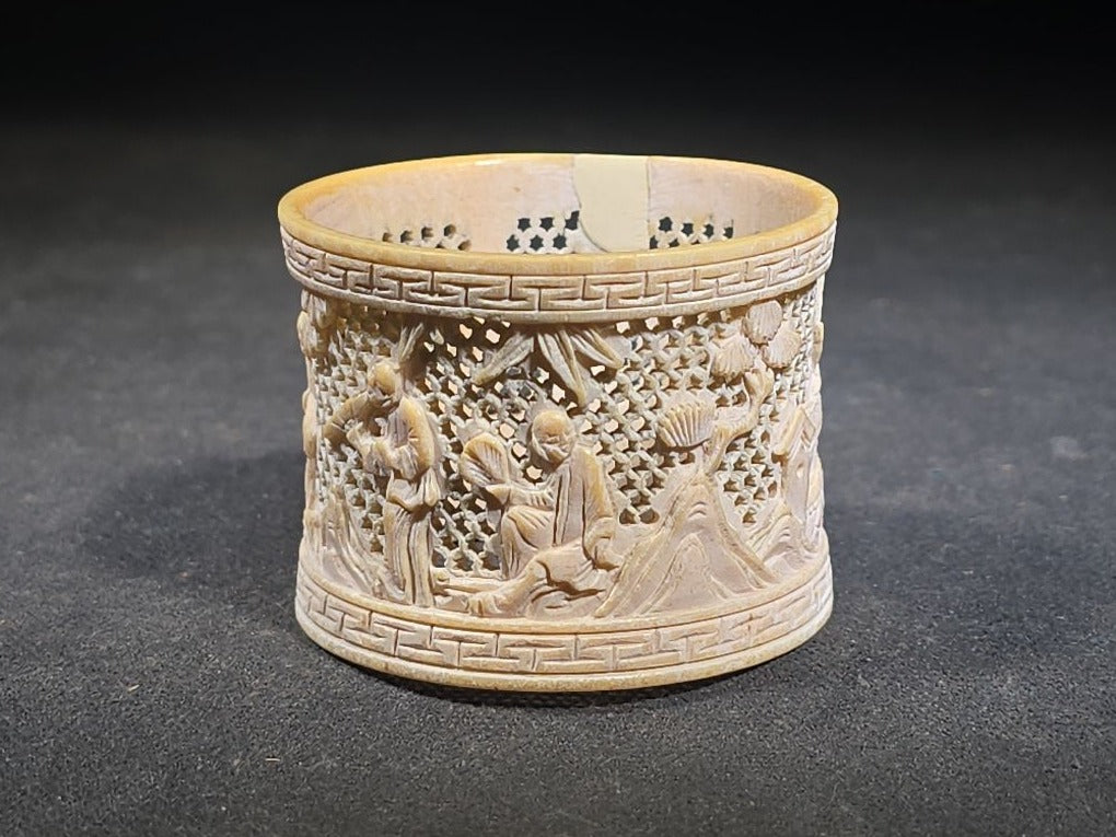 Antique Chinese Carved and Reticulated Bone Napkin Ring with Figures in Landscape and Geometric Borders