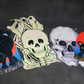 Lot 113 - Grouping of Four Vintage Die-Cut Halloween Paper Decorations Including Glow-In-The-Dark Jointed Skeleton, Skull, and Two Black Cats