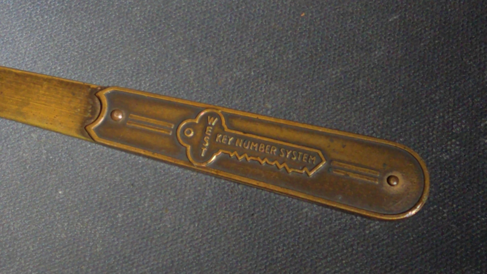 Grouping of Seven Antique and Vintage Smalls including Four Letter Openers, Brass Buckle, Stanley Ruler, and Screw-Top Drill Bit Holder