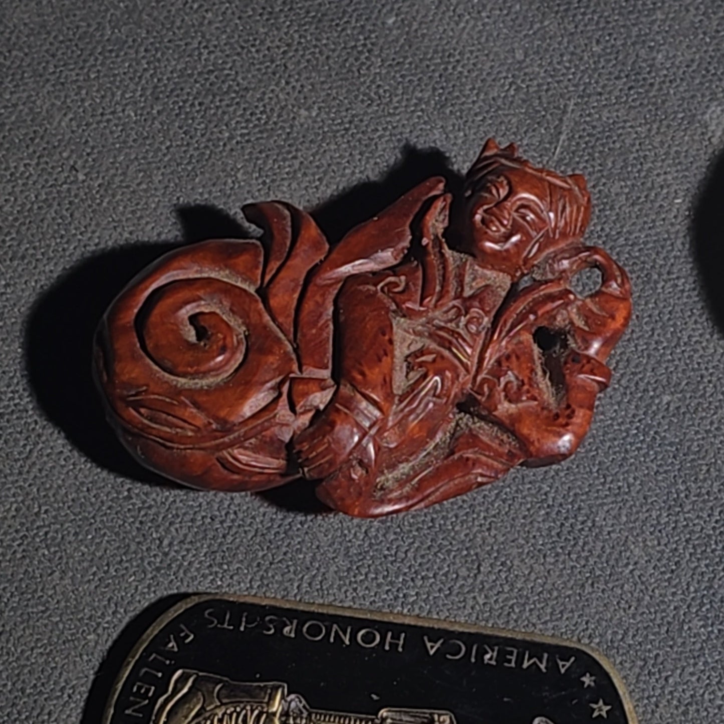 Grouping of Vintage and Modern Smalls including Carved Wood Figure, Carved Netsuke-Style Figure, U.S.M.C. Pin, United States Army Dog Tag Pendant, and Miniature Padlock