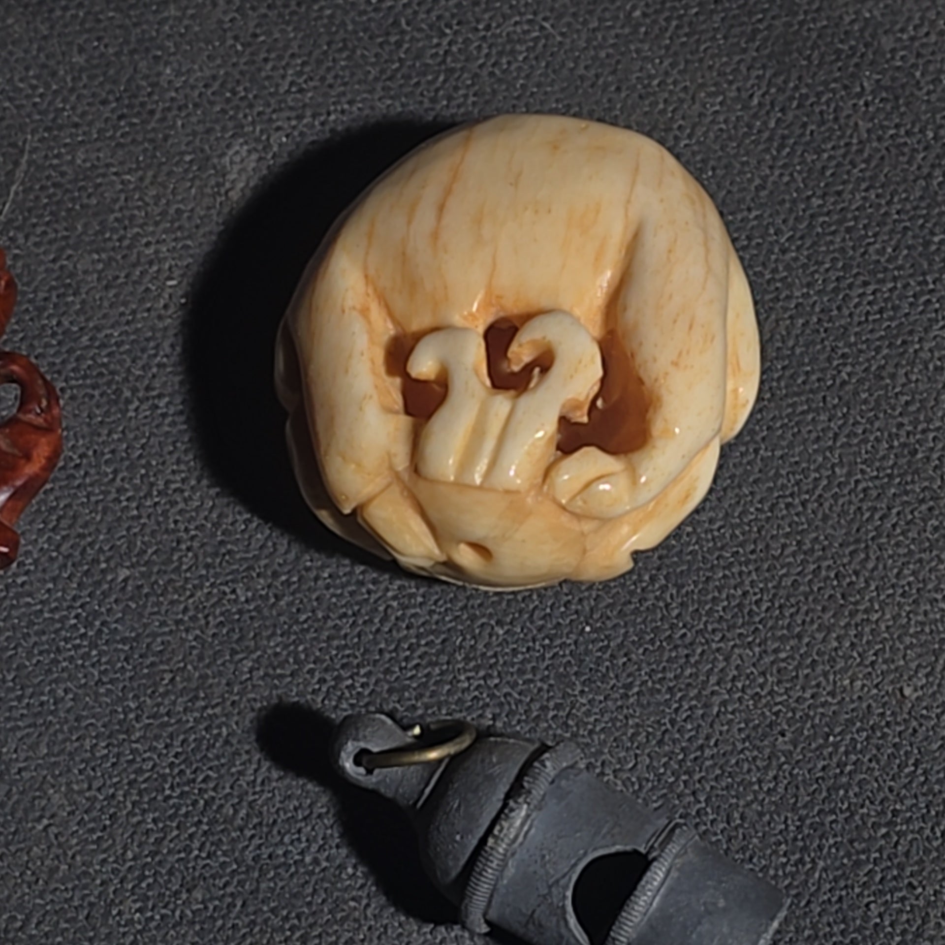 Grouping of Vintage and Modern Smalls including Carved Wood Figure, Carved Netsuke-Style Figure, U.S.M.C. Pin, United States Army Dog Tag Pendant, and Miniature Padlock