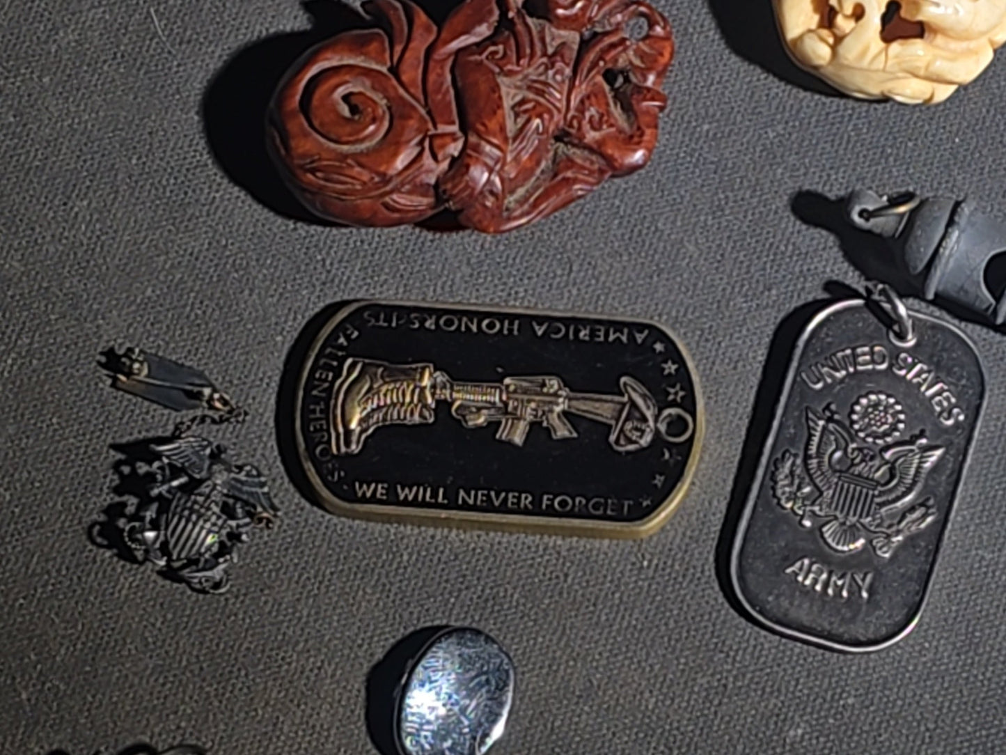 Grouping of Vintage and Modern Smalls including Carved Wood Figure, Carved Netsuke-Style Figure, U.S.M.C. Pin, United States Army Dog Tag Pendant, and Miniature Padlock