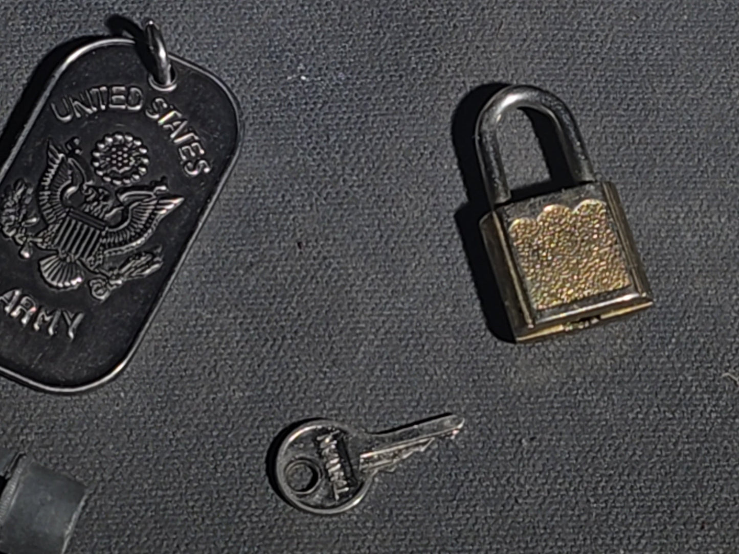 Grouping of Vintage and Modern Smalls including Carved Wood Figure, Carved Netsuke-Style Figure, U.S.M.C. Pin, United States Army Dog Tag Pendant, and Miniature Padlock