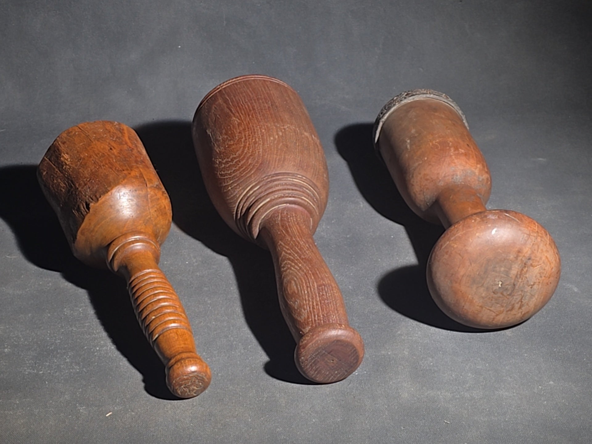 Grouping of Four Antique Wooden Kitchen Tools including Three Turned Mashers and a Handled Reamer