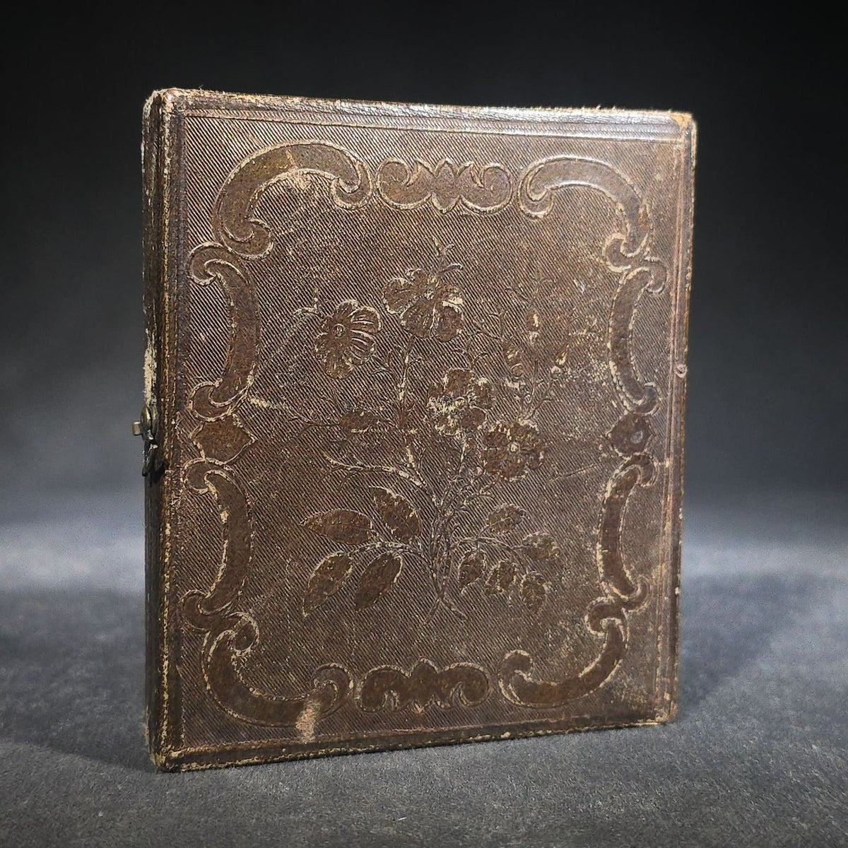 Antique 1/6th Plate Daguerreotype Photograph of a Child Standing Beside a Cloth-Covered Table with a Cap in Full Intact Leatherette Union Case with Embossed Floral and Scroll Design