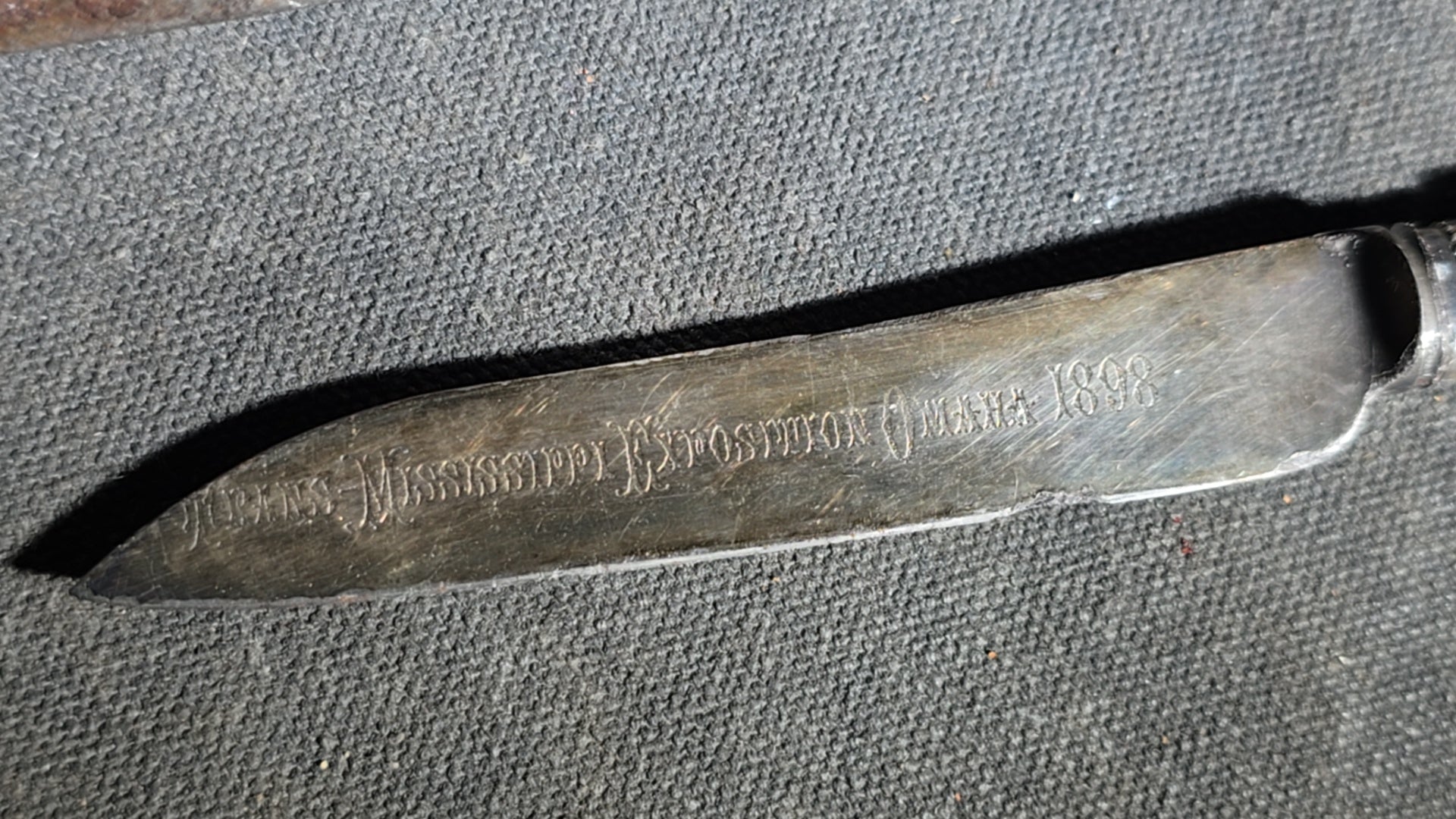 Grouping of Four Antique Carving Pieces including Trans-Mississippi Exposition Omaha 1898 Souvenir Knife, Stag-Handle Carving Knife and Fork, and Wood-Handle Carving Fork