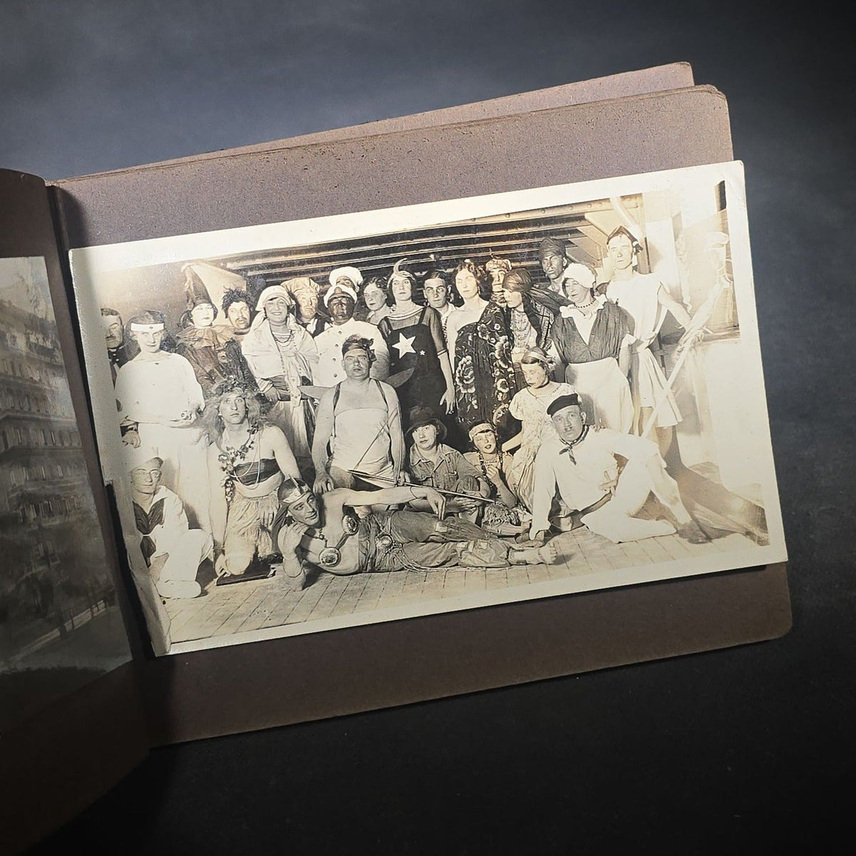 Antique Snapshot Photo Album Containing 45+ Snapshot Photographs, German-Captioned Transatlantic Voyage Aboard the R.M.S. Majestic with New York City Street Scenes, Shipboard Costume Party, Dining Room Interior, and Portraits