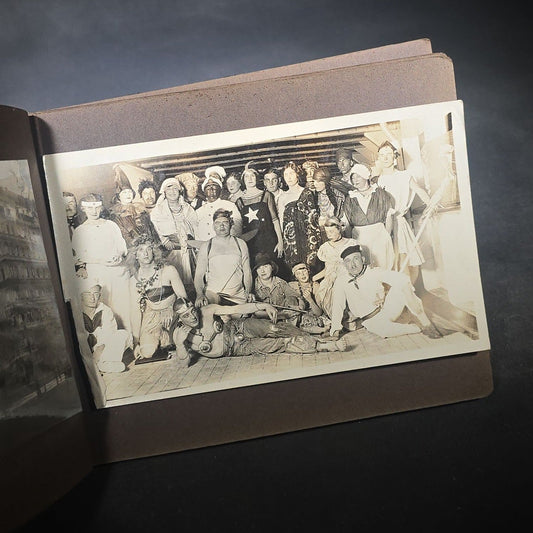 Antique Snapshot Photo Album Containing 45+ Snapshot Photographs, German-Captioned Transatlantic Voyage Aboard the R.M.S. Majestic with New York City Street Scenes, Shipboard Costume Party, Dining Room Interior, and Portraits