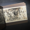 Lot 014 - Antique Snapshot Photo Album Containing 45+ Snapshot Photographs, German-Captioned Transatlantic Voyage Aboard the R.M.S. Majestic with New York City Street Scenes, Shipboard Costume Party, Dining Room Interior, and Portraits