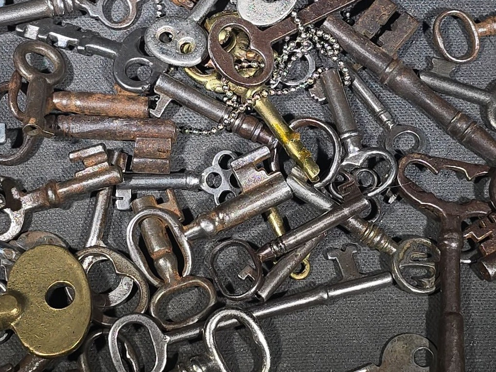 Grouping of 50+ Antique and Vintage Skeleton Keys including Barrel Keys, Cabinet Keys, and Padlock Keys