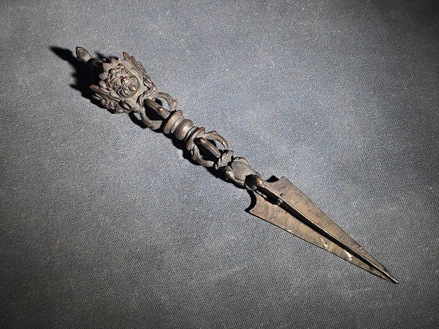 Antique Tibetan Bronze Phurba Ceremonial Ritual Dagger with Wrathful Deity Head and Triangular Blade