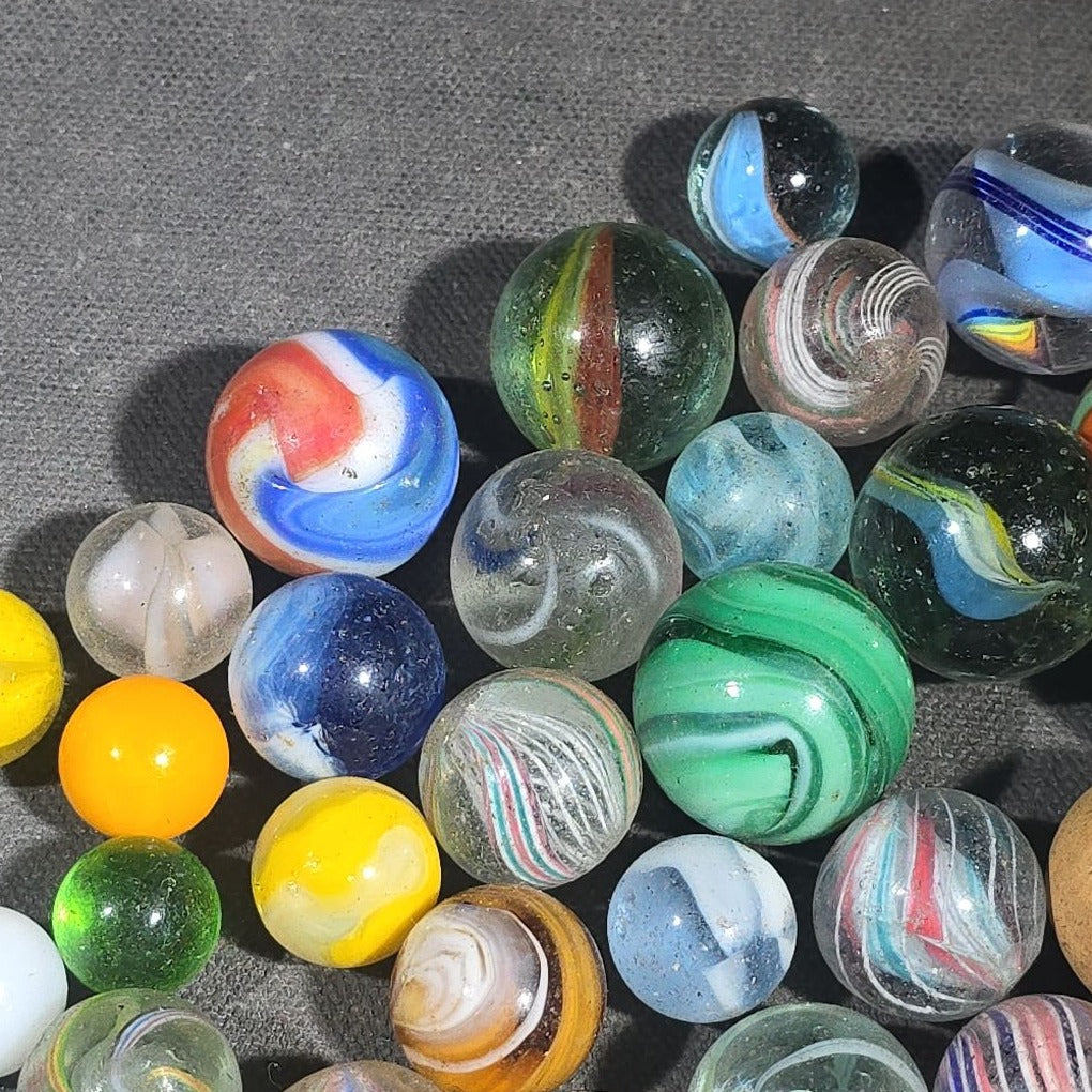 Grouping of 65+ Antique and Vintage Glass Marbles including Handmade German Swirls, Sulphide with Animal Figure, China, Clay, and UV-Reactive Glowing Examples