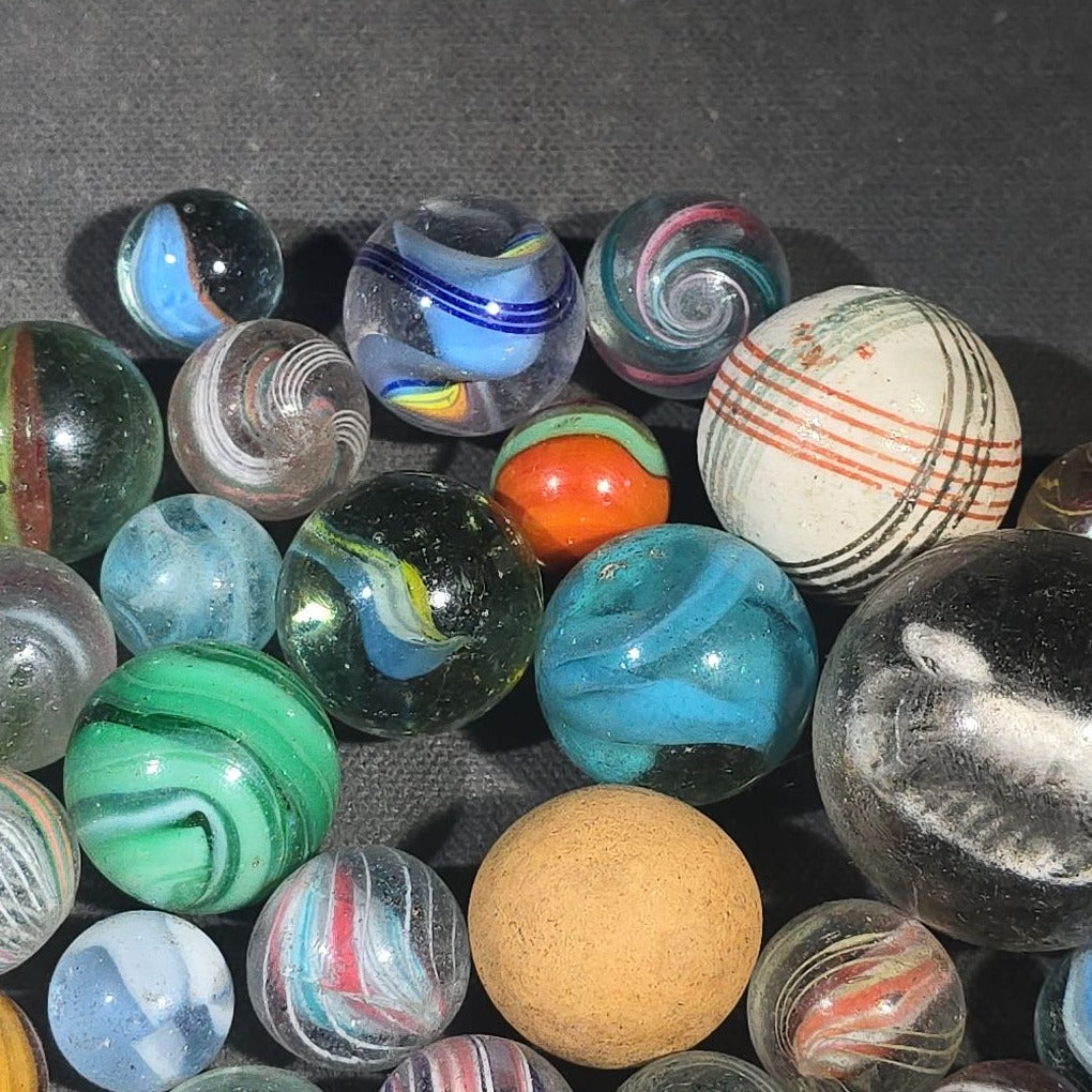 Grouping of 65+ Antique and Vintage Glass Marbles including Handmade German Swirls, Sulphide with Animal Figure, China, Clay, and UV-Reactive Glowing Examples