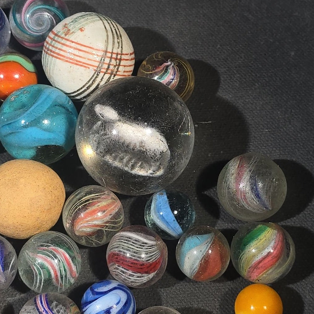 Grouping of 65+ Antique and Vintage Glass Marbles including Handmade German Swirls, Sulphide with Animal Figure, China, Clay, and UV-Reactive Glowing Examples