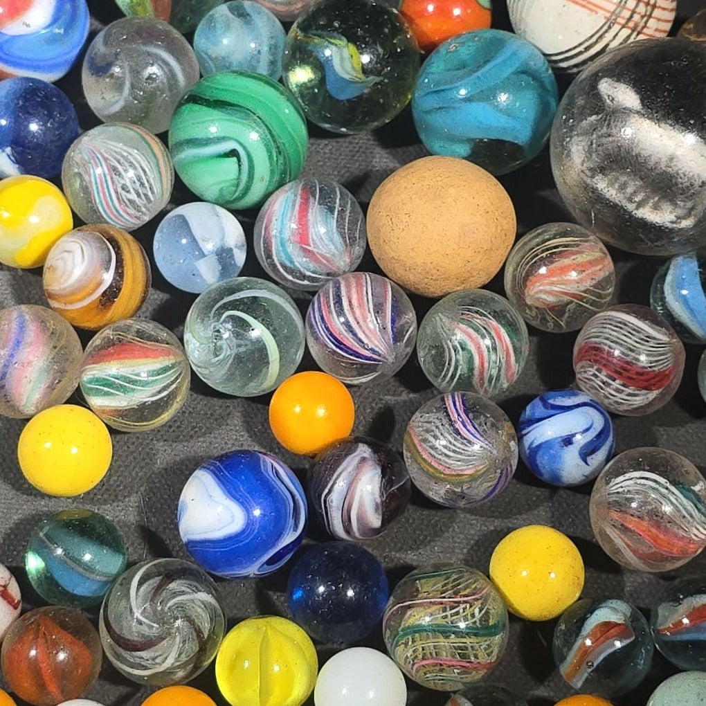 Grouping of 65+ Antique and Vintage Glass Marbles including Handmade German Swirls, Sulphide with Animal Figure, China, Clay, and UV-Reactive Glowing Examples