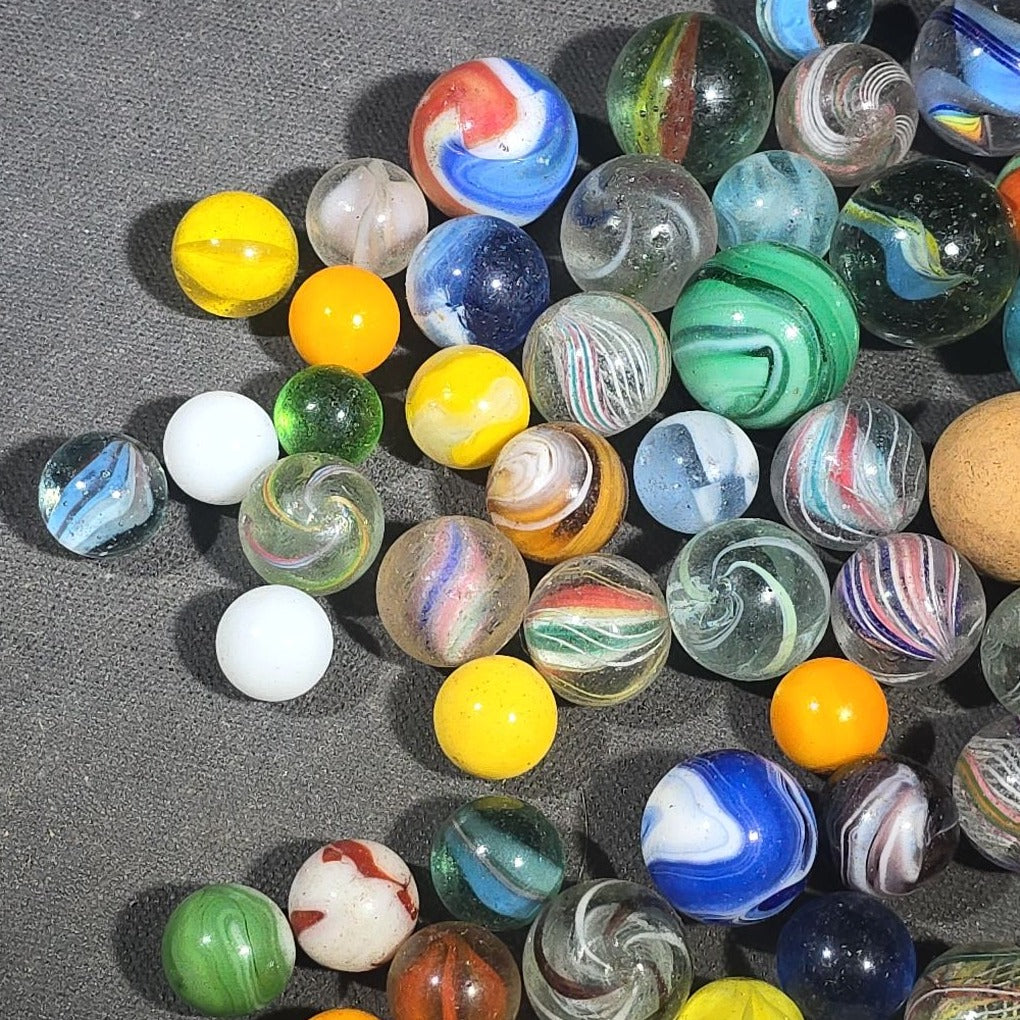 Grouping of 65+ Antique and Vintage Glass Marbles including Handmade German Swirls, Sulphide with Animal Figure, China, Clay, and UV-Reactive Glowing Examples