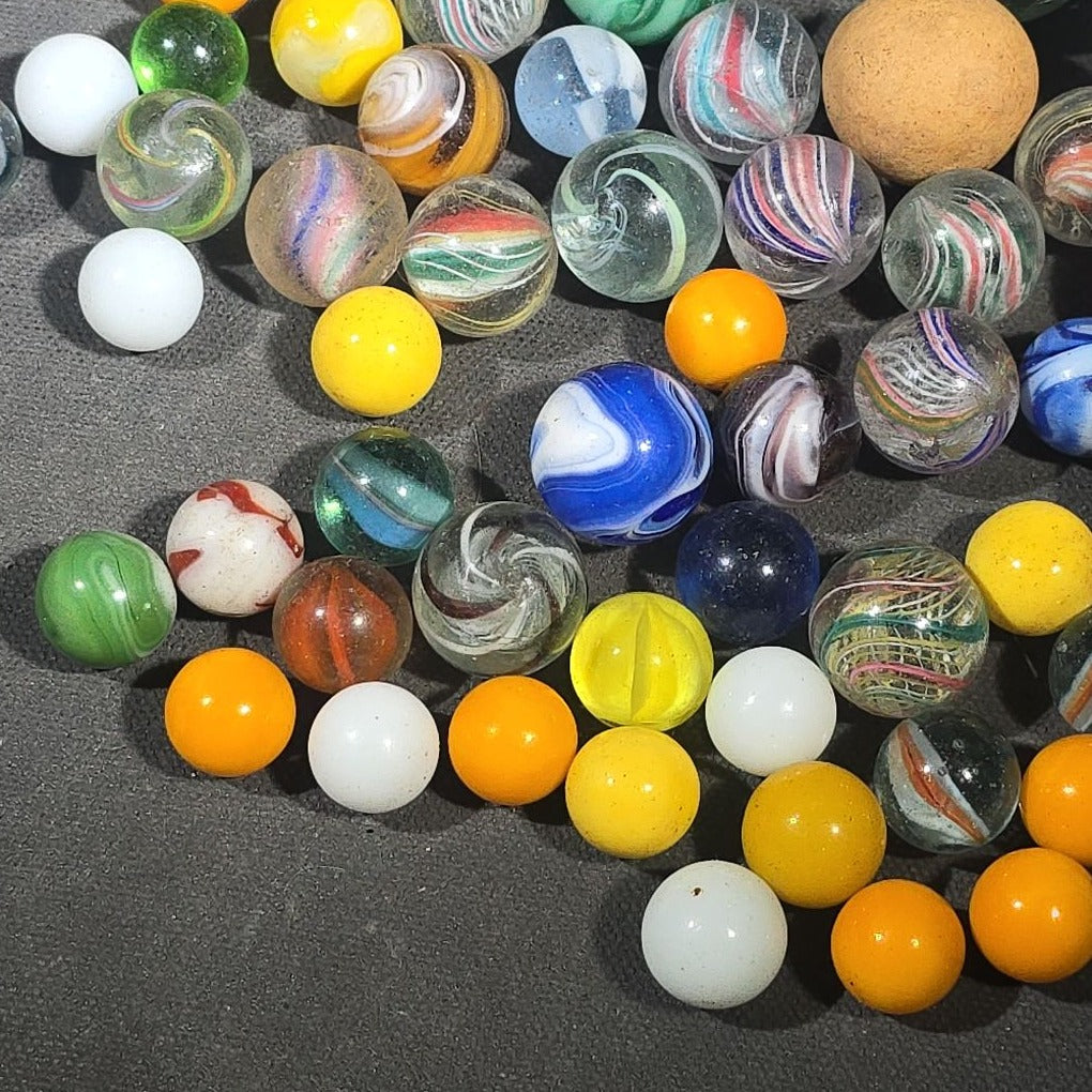 Grouping of 65+ Antique and Vintage Glass Marbles including Handmade German Swirls, Sulphide with Animal Figure, China, Clay, and UV-Reactive Glowing Examples