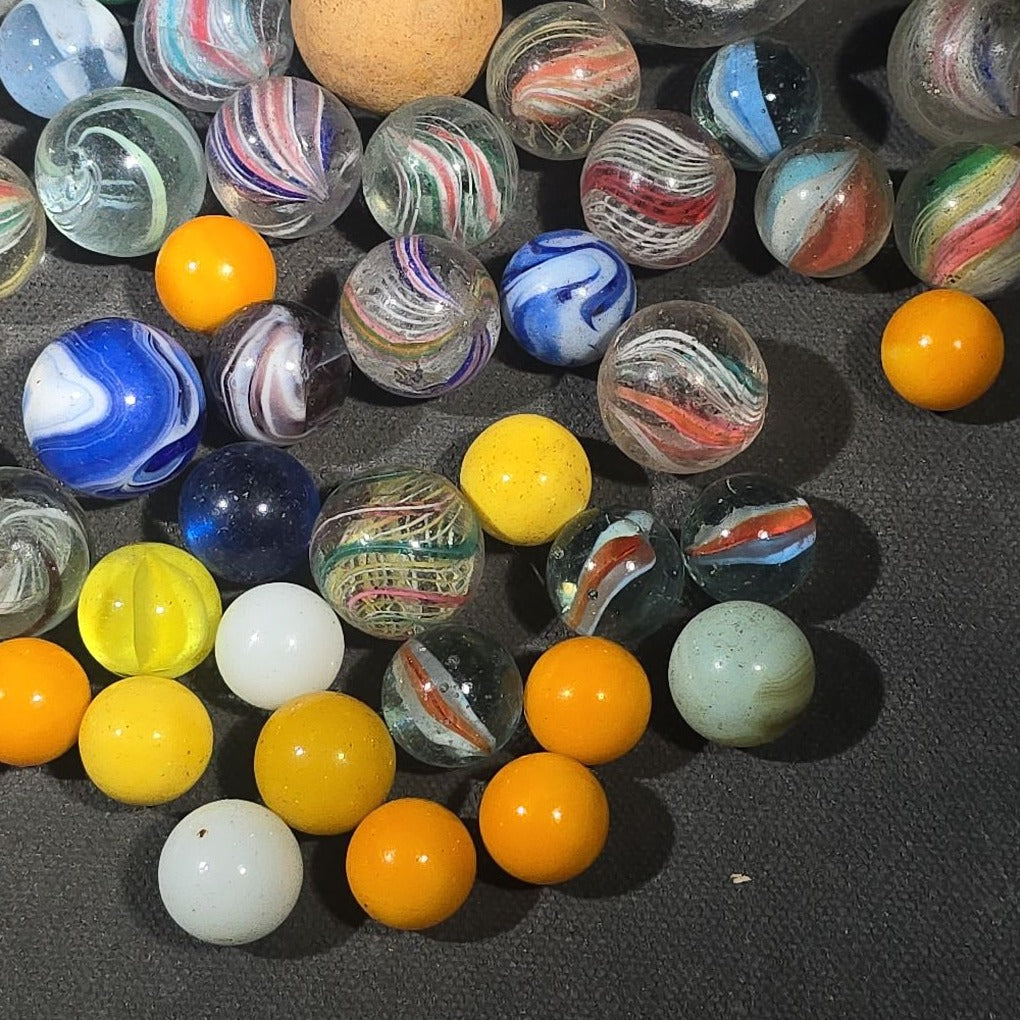 Grouping of 65+ Antique and Vintage Glass Marbles including Handmade German Swirls, Sulphide with Animal Figure, China, Clay, and UV-Reactive Glowing Examples