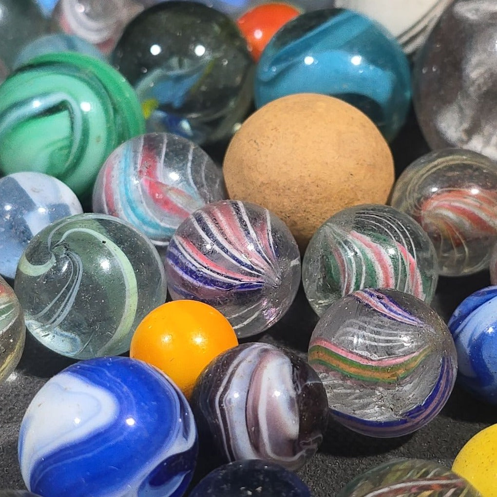 Grouping of 65+ Antique and Vintage Glass Marbles including Handmade German Swirls, Sulphide with Animal Figure, China, Clay, and UV-Reactive Glowing Examples