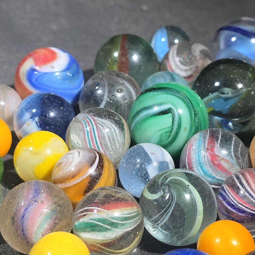 Grouping of 65+ Antique and Vintage Glass Marbles including Handmade German Swirls, Sulphide with Animal Figure, China, Clay, and UV-Reactive Glowing Examples