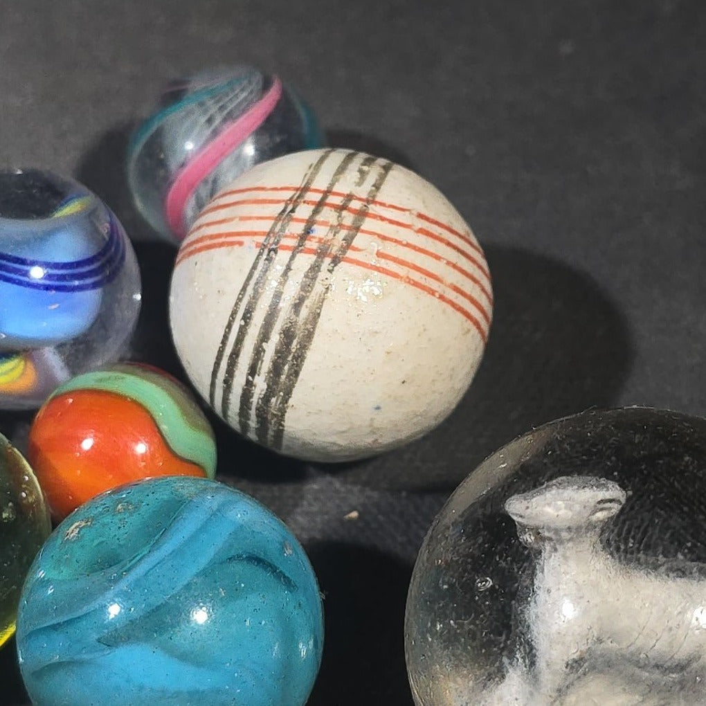 Grouping of 65+ Antique and Vintage Glass Marbles including Handmade German Swirls, Sulphide with Animal Figure, China, Clay, and UV-Reactive Glowing Examples