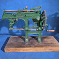 Lot 172 - Antique Bonanza Cast Iron Apple Parer, Manufactured by Goodell Co., Antrim, New Hampshire, U.S.A., Mounted on Wood Board, 24" L x 17-1/2" H