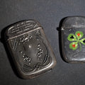 Lot 067 - Pair of Antique Sterling Silver Match Safes Including Art Nouveau Floral Example and Enameled Four-Leaf Clover with Card Suit Symbols, Total Weight 54.76 g